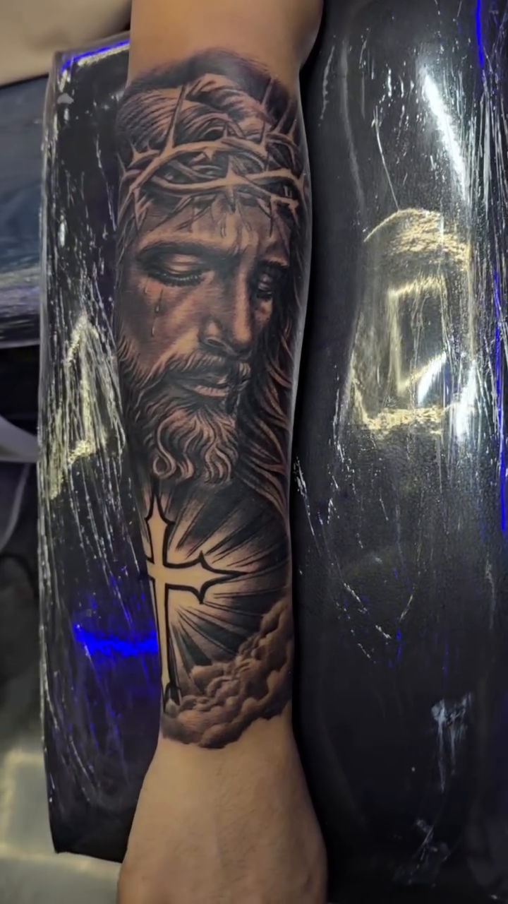 Jesus Christ with a cross realism tattoo by Richie Garcia, Hesperia, California