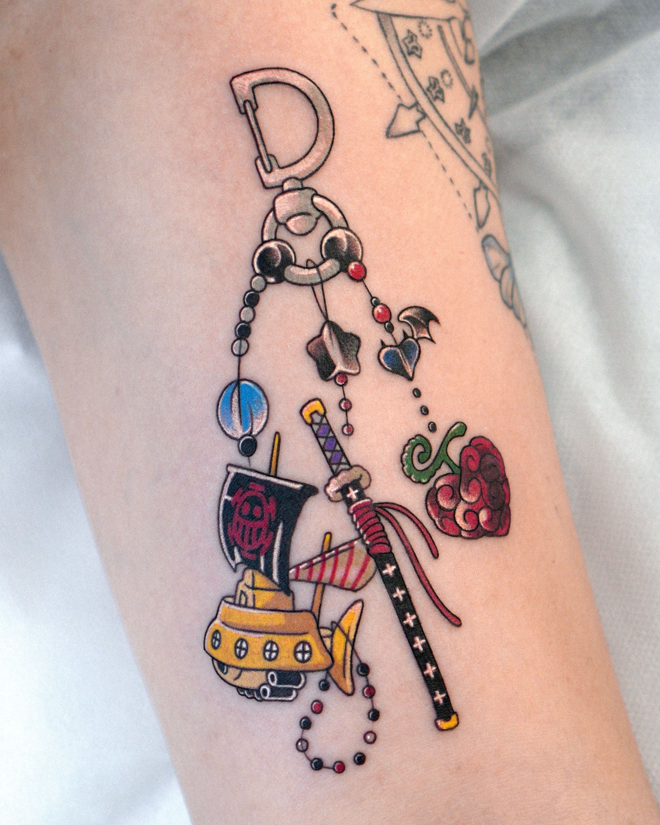 Jewelry and sword American traditional tattoo on the forearm by Eden