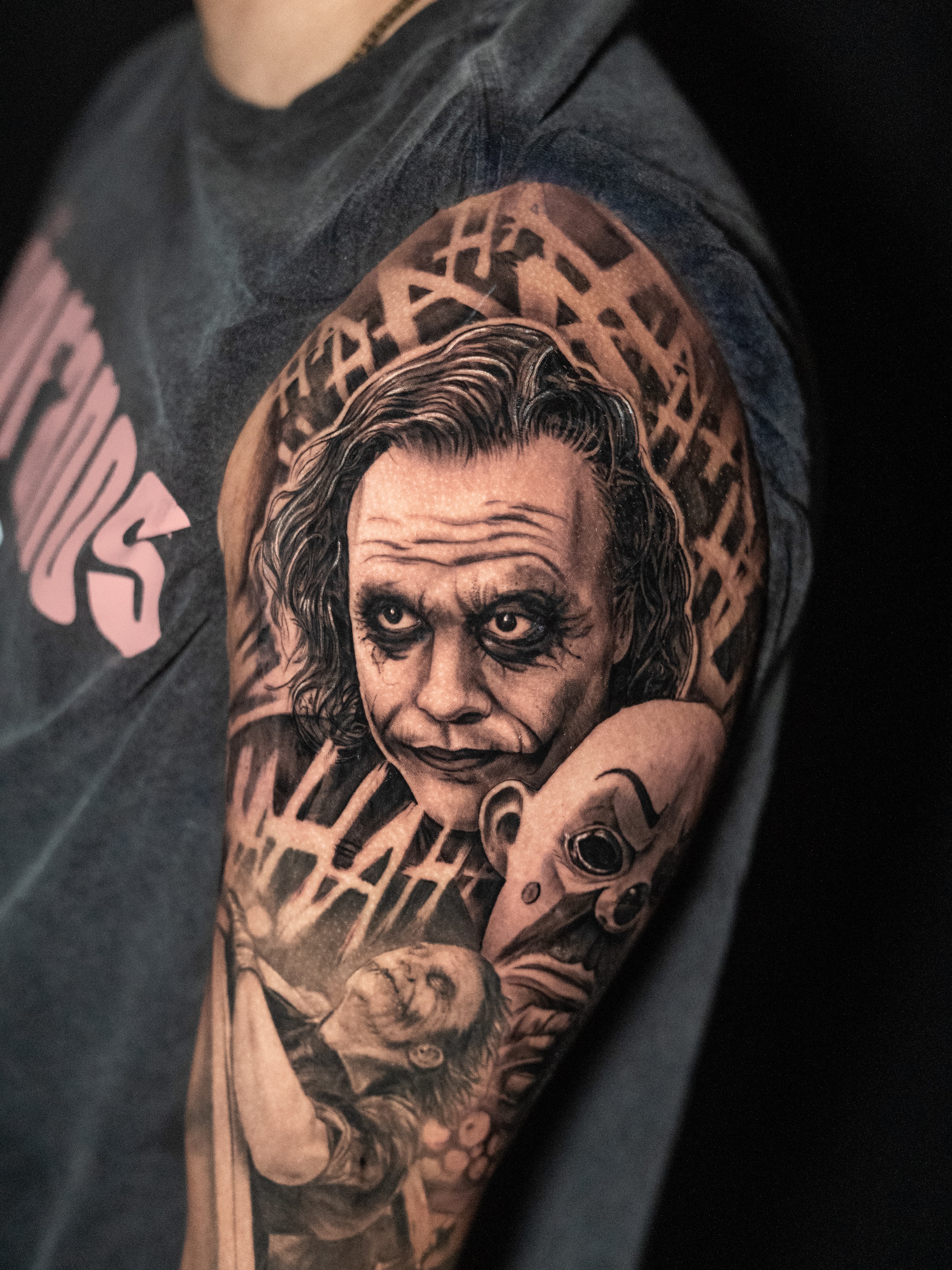 The Joker and a mask realism tattoo on the forearm by James Jurado