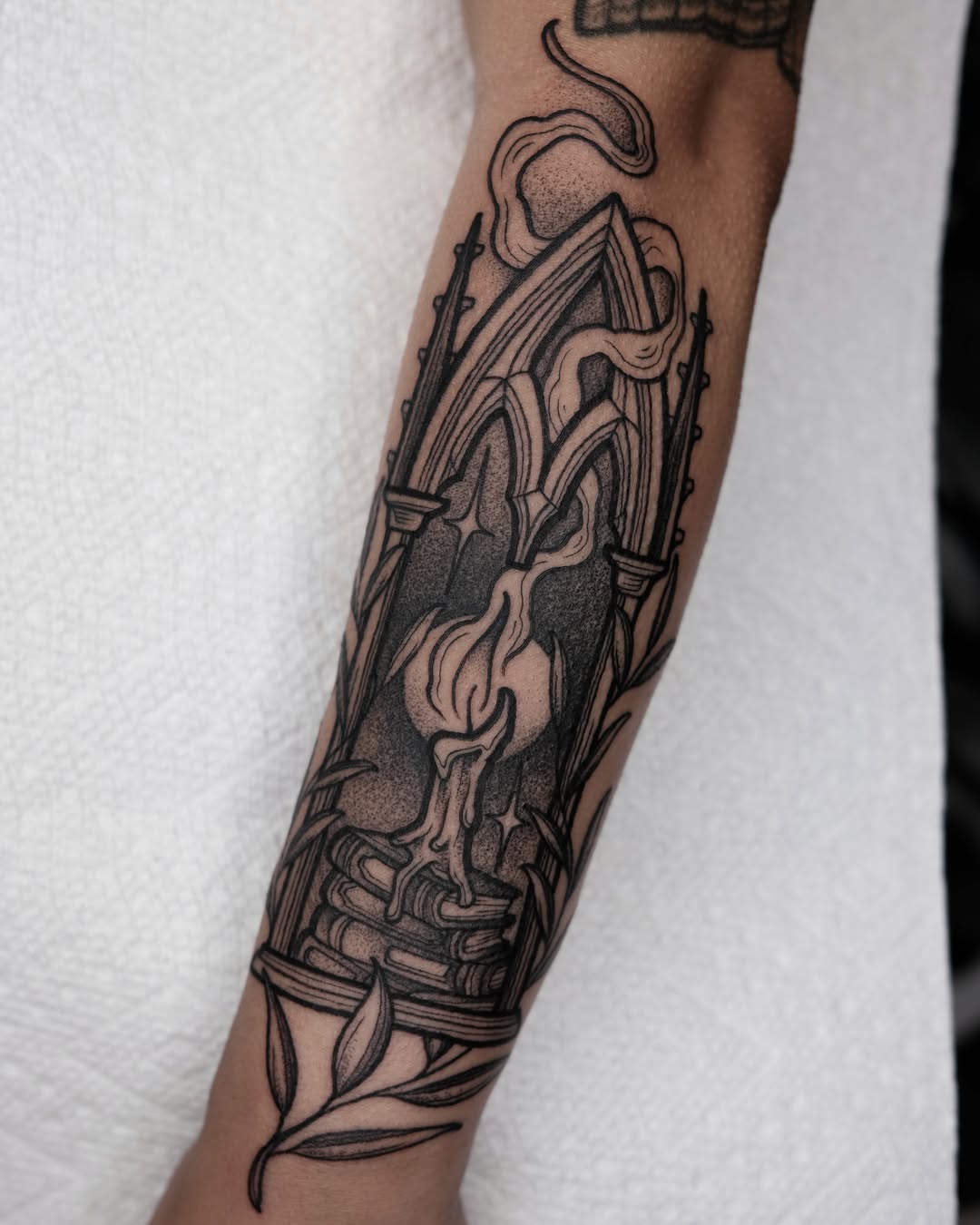Gothic arch and candle black and grey tattoo on the forearm by Kyle Patrick