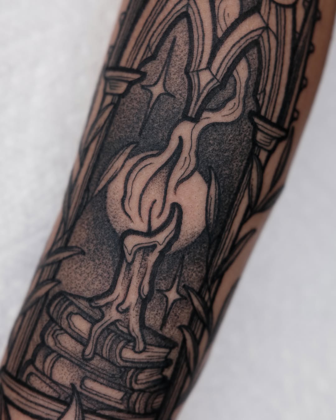 Candle flame black and grey tattoo on the forearm by Kyle Patrick