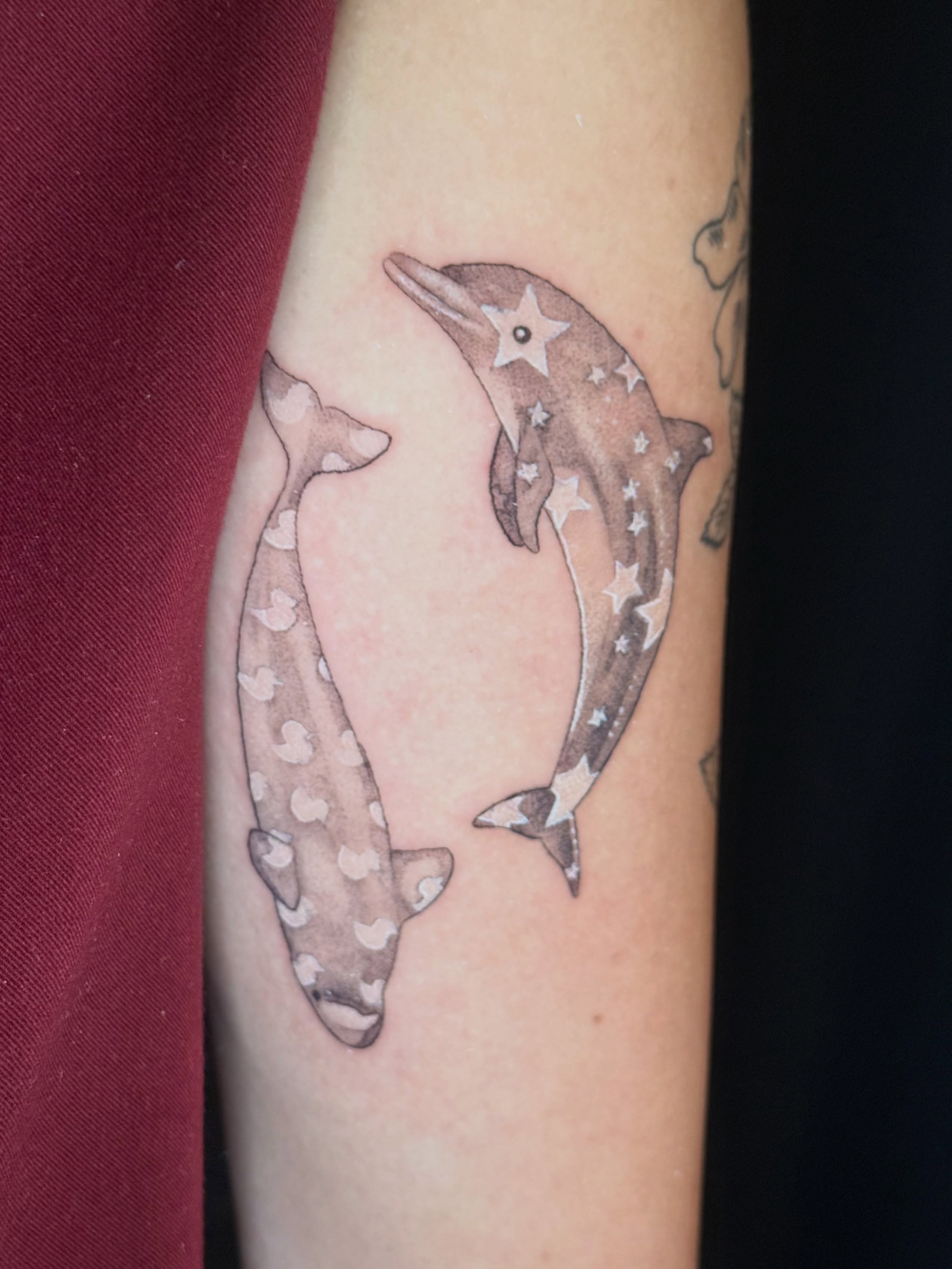 Dolphins dotwork tattoo on the forearm by Olivia, Royal Oak, Michigan