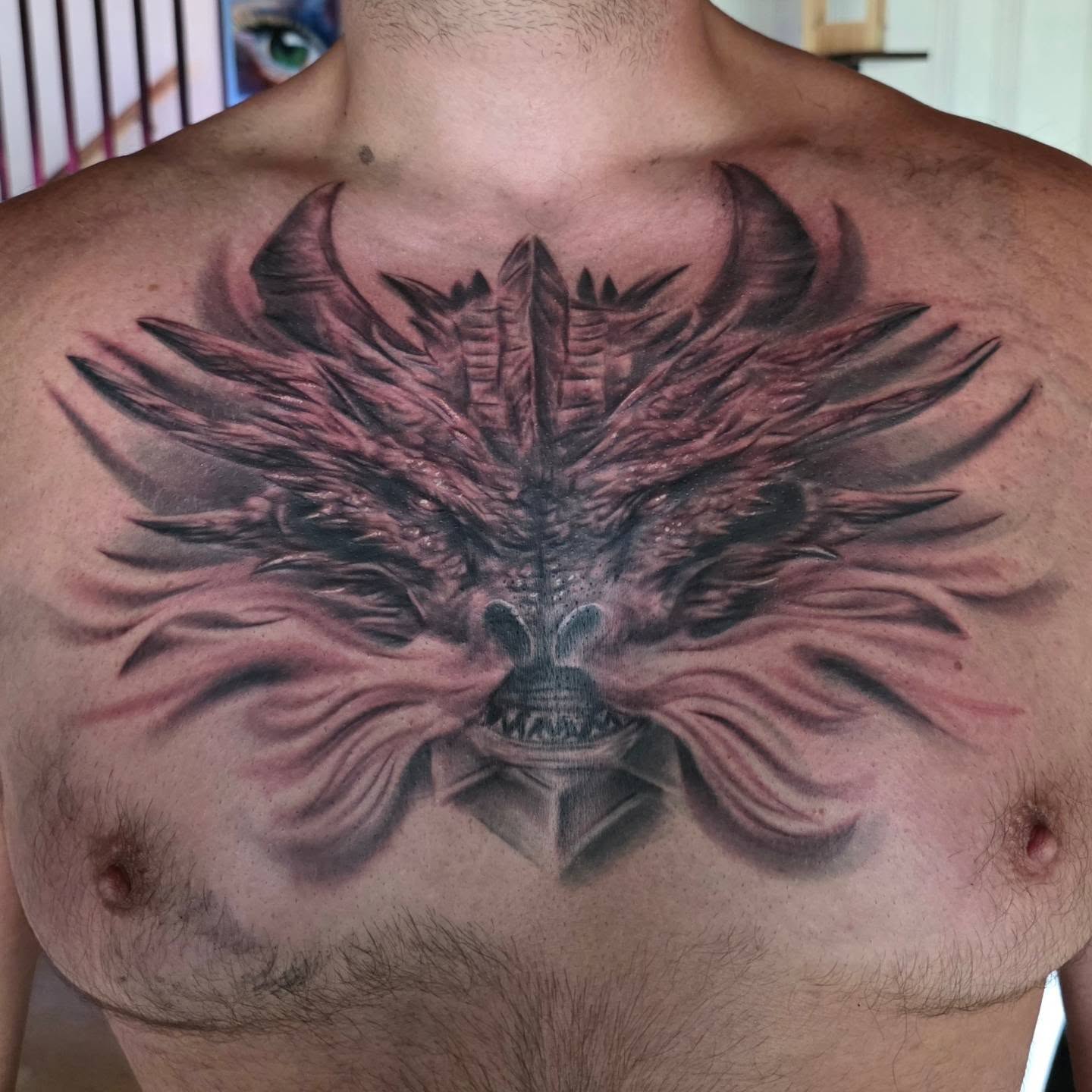 Winged dragon realism tattoo on the chest by Kosta