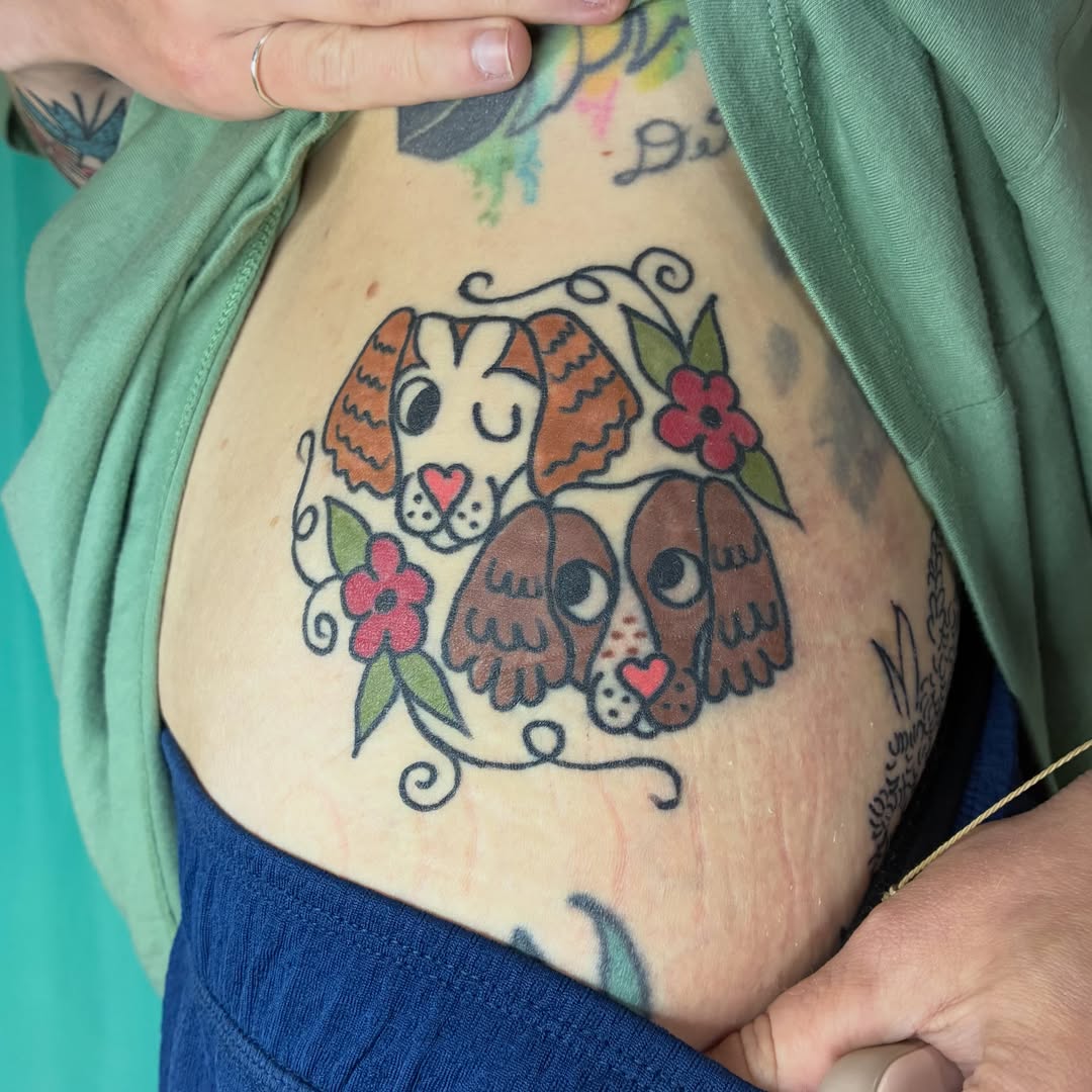 Dogs American traditional tattoo on the torso by Kaily McKee