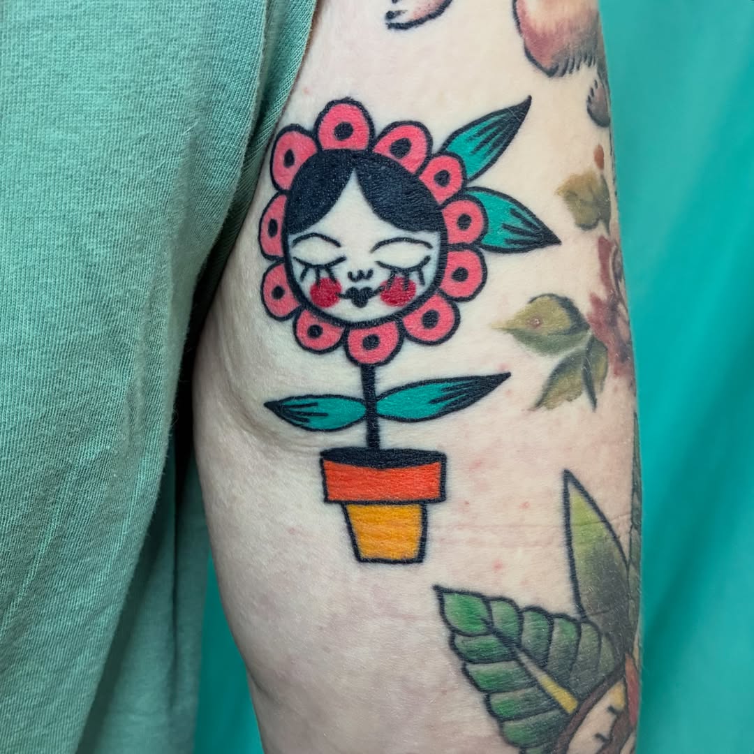 Flower doll American traditional tattoo on the forearm by Kaily McKee