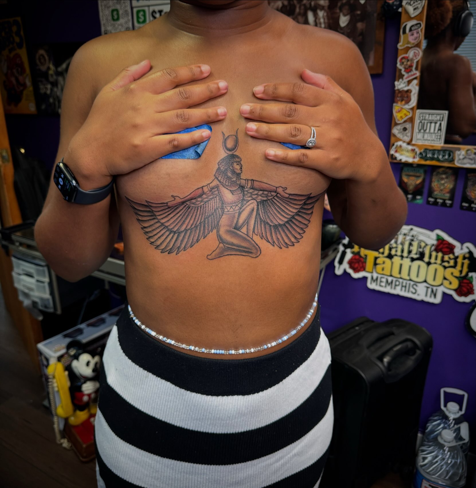Egyptian deity with wings black and grey tattoo on the chest by Christian Goines, Memphis, Tennessee