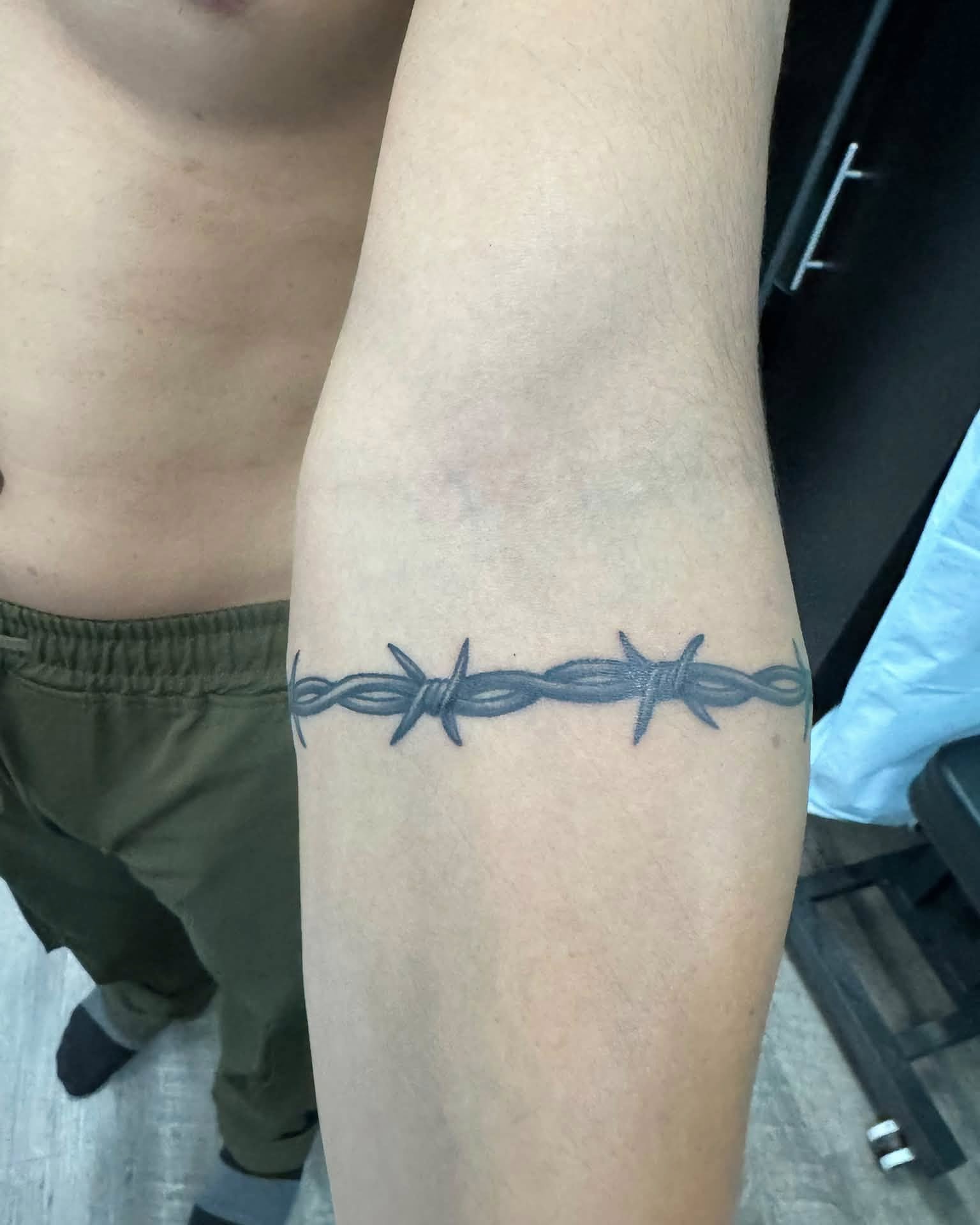 Barbed wire black and grey tattoo on the forearm by Skott Kautman, Dubuque, Iowa