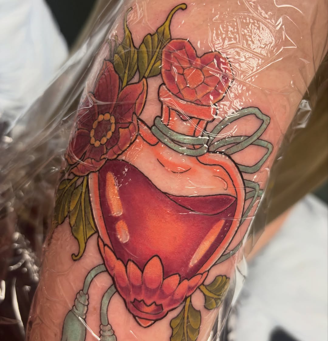 Potion bottle with flowers American traditional tattoo on the forearm by Rachel Foster