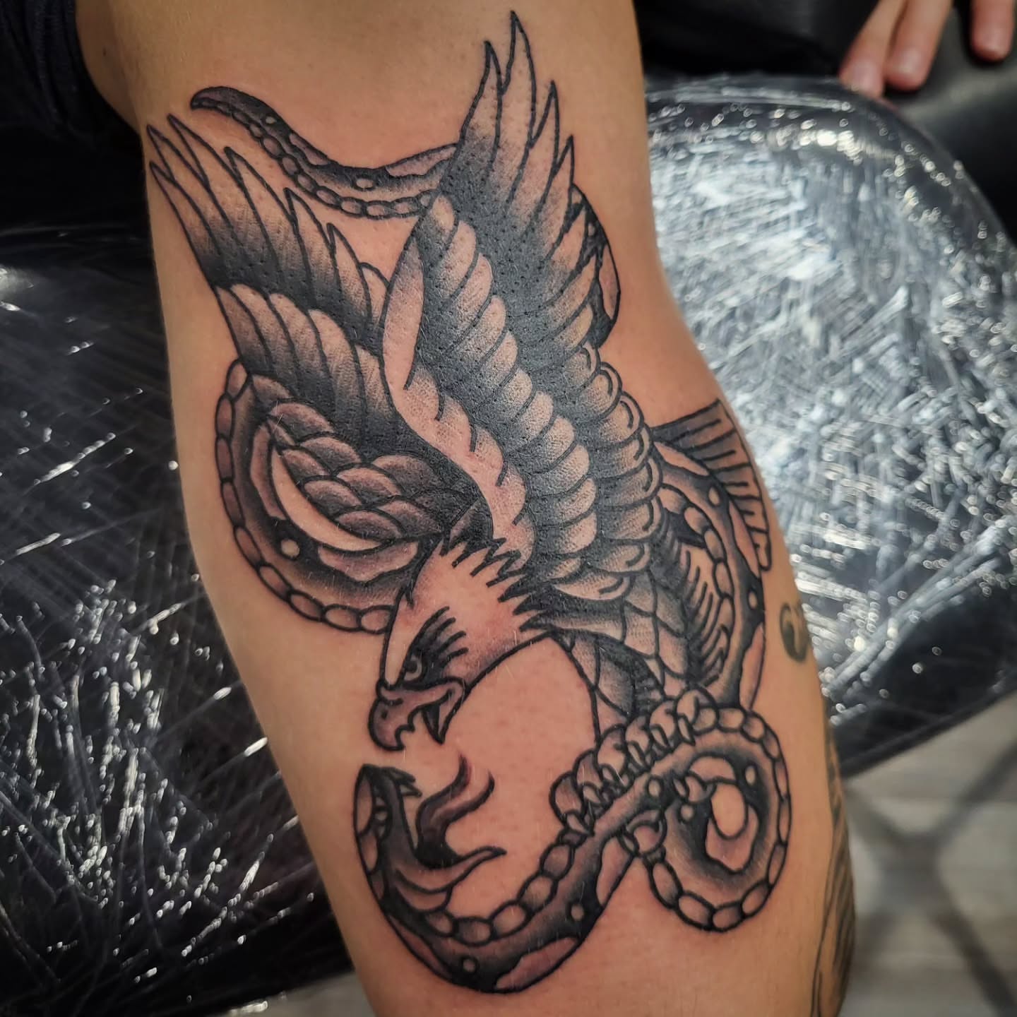 Eagle and snake American traditional tattoo on the thigh by Sloan Smith