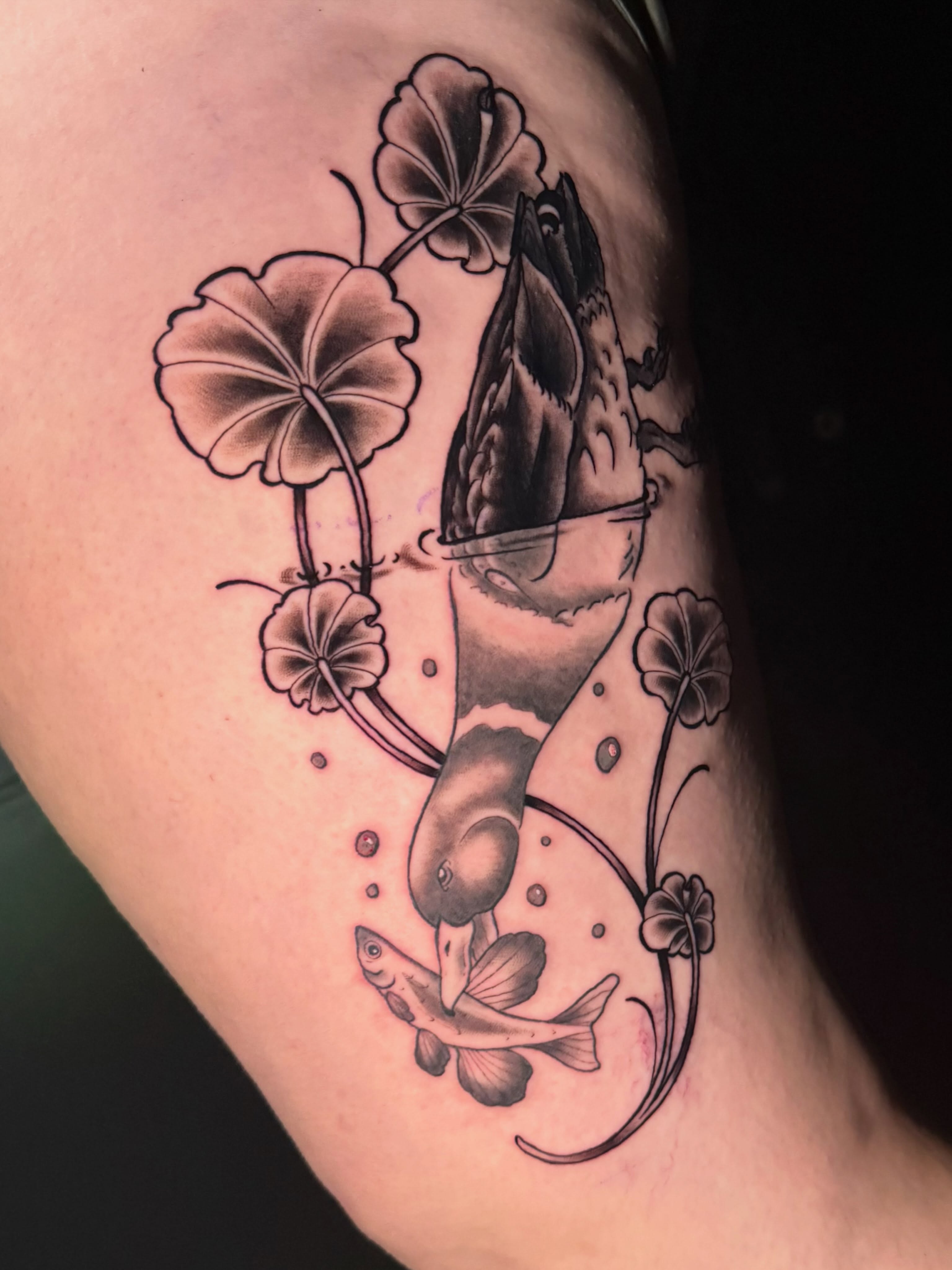 Fish and lotus black and grey tattoo on the thigh by Taylor Kay 🌿