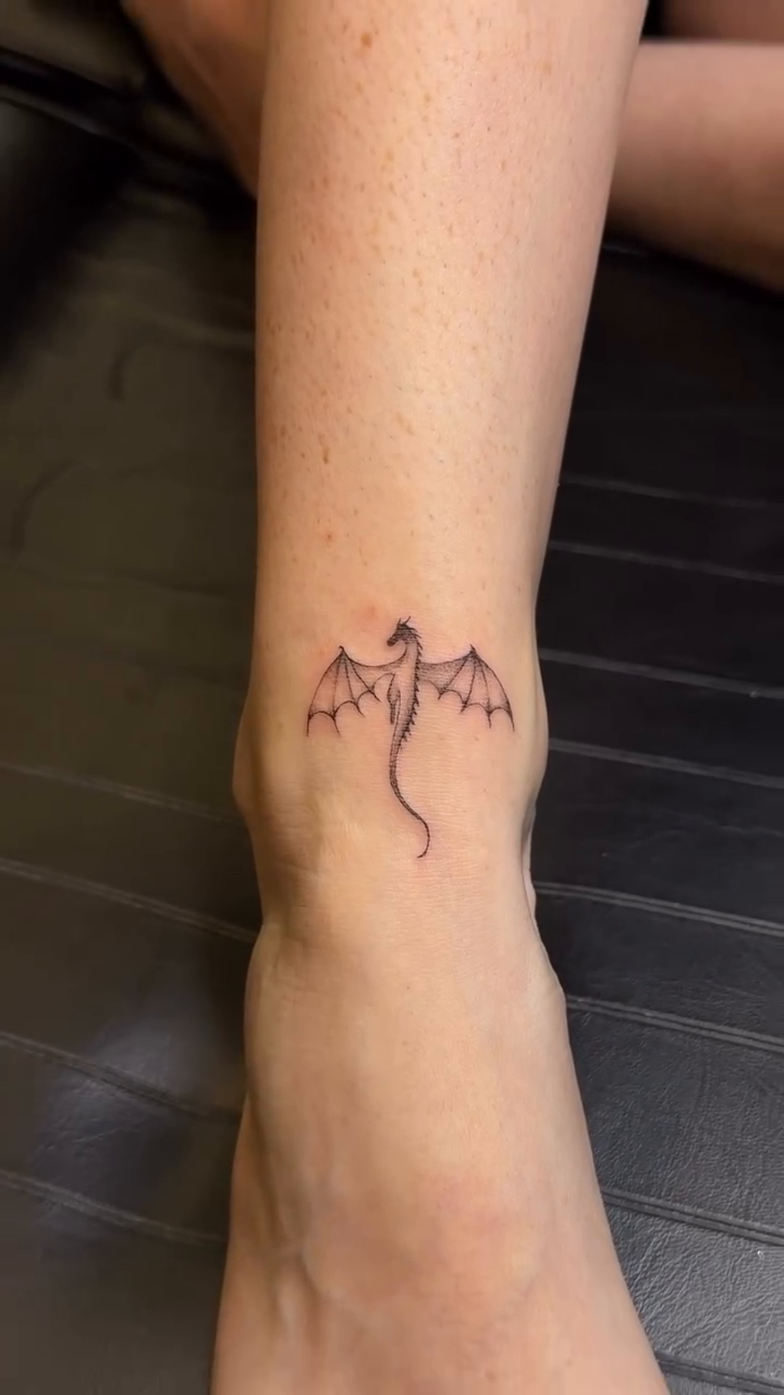 Dragon fine line tattoo on the forearm by Pretty Ugly Tattoos