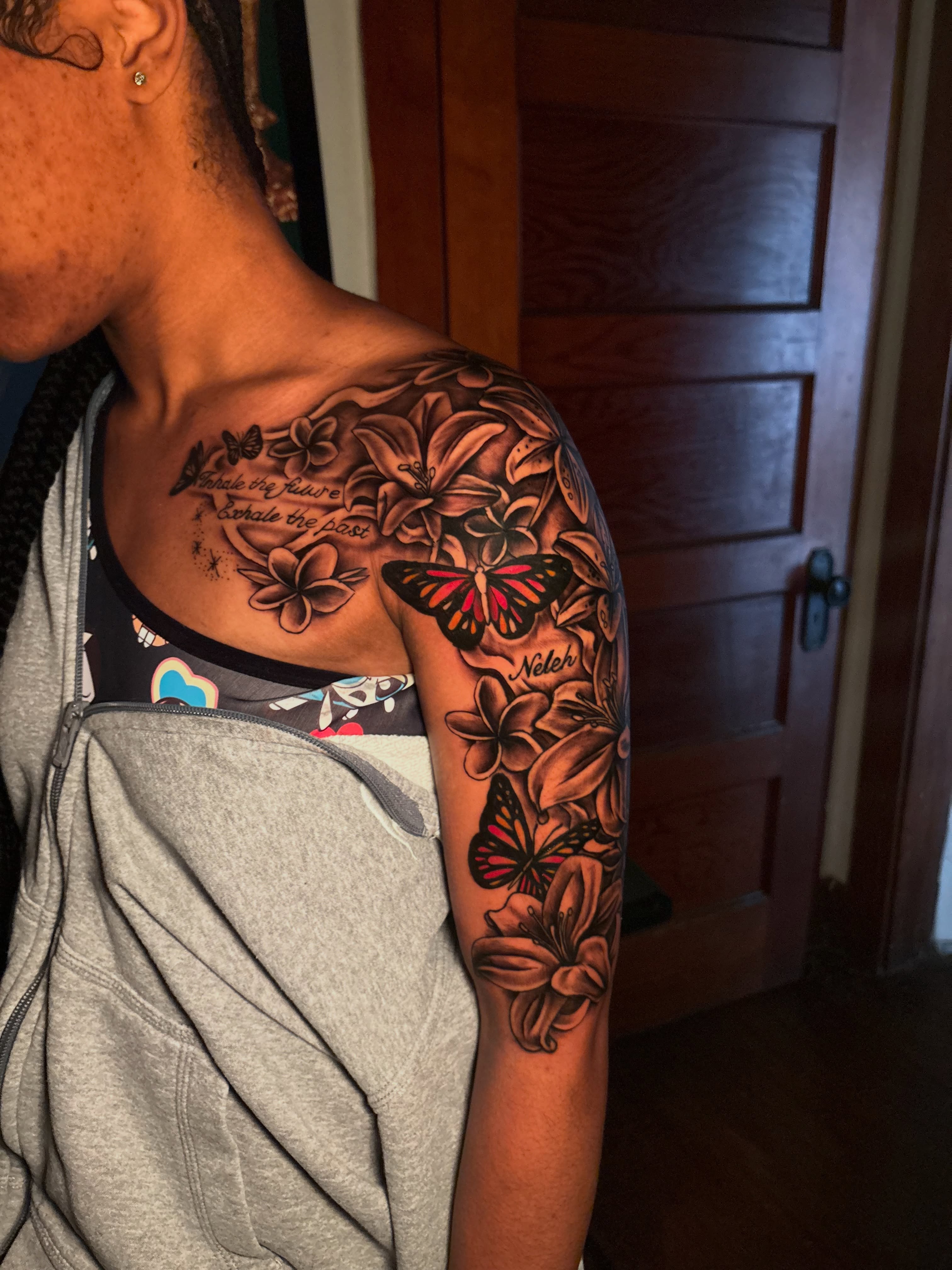 Floral and butterfly design realism tattoo on the shoulder by Maleek Inkz