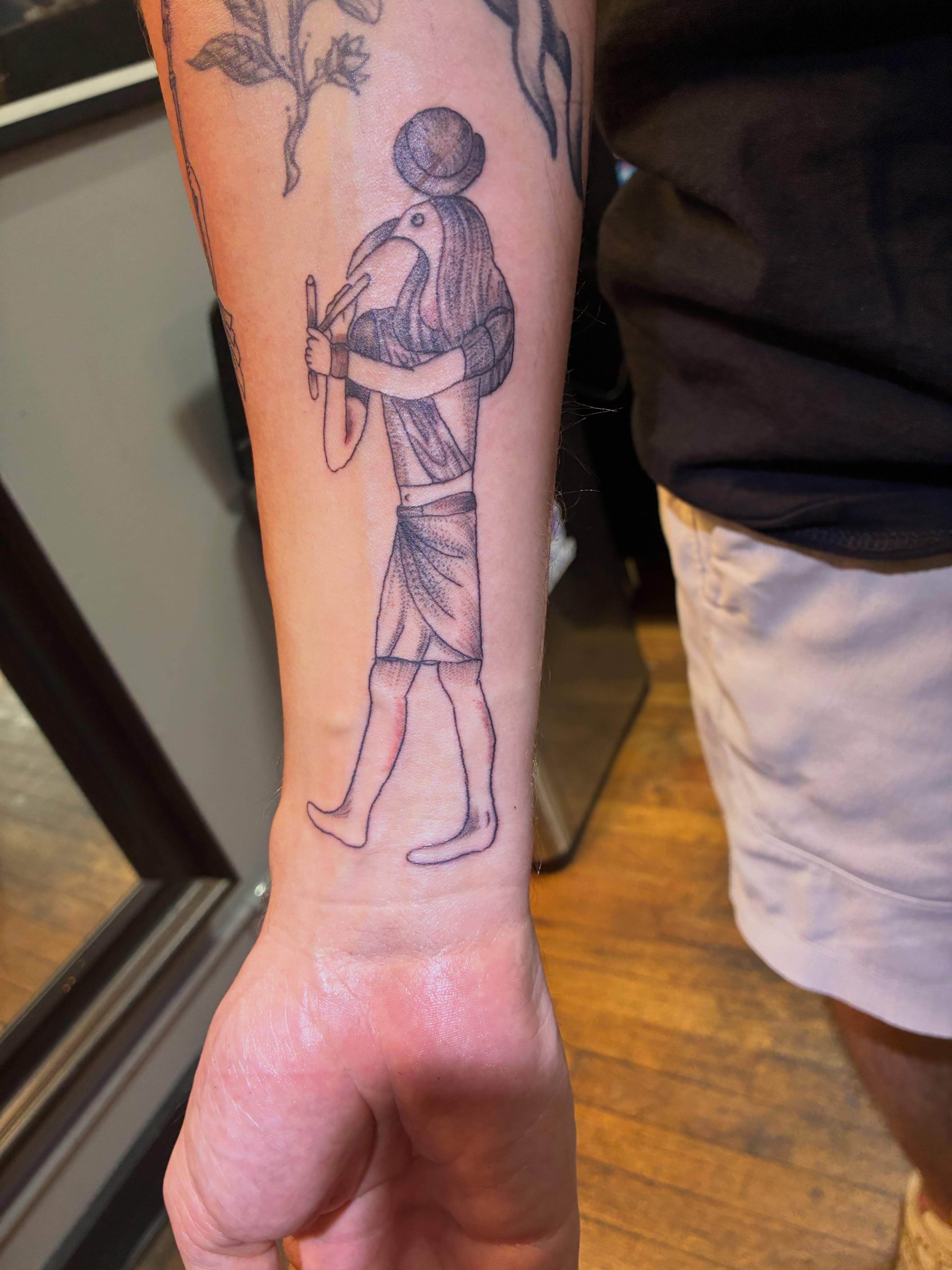 Ancient figure black and grey tattoo on the forearm by Seattle Tattoo Artist