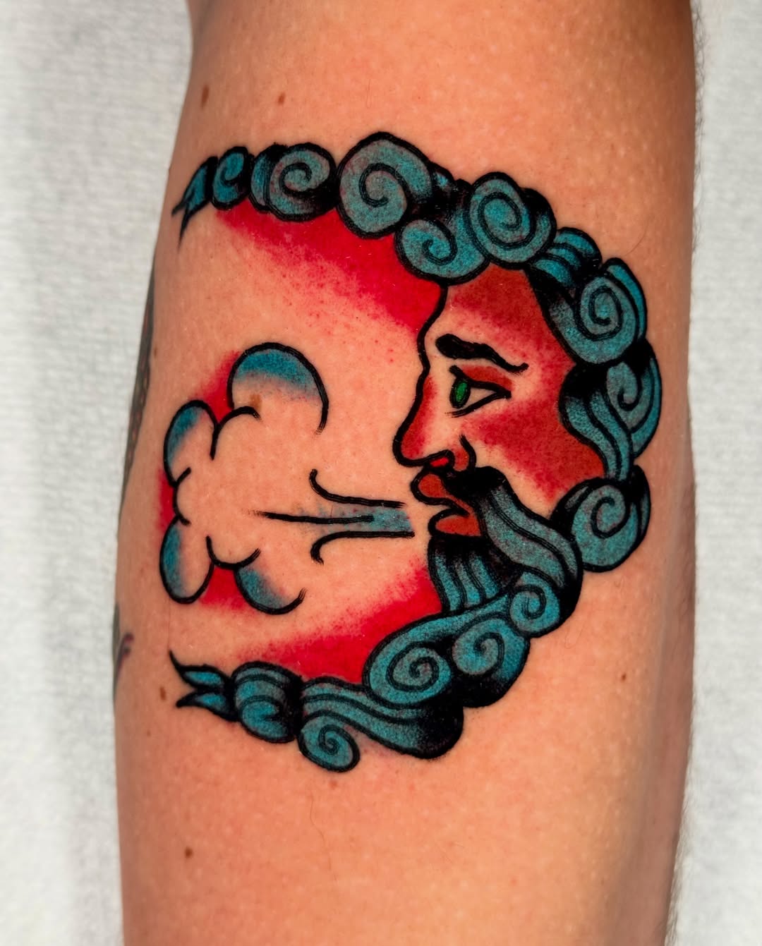 Sun and cloud American traditional tattoo on the forearm by Joe Bear Tattooer
