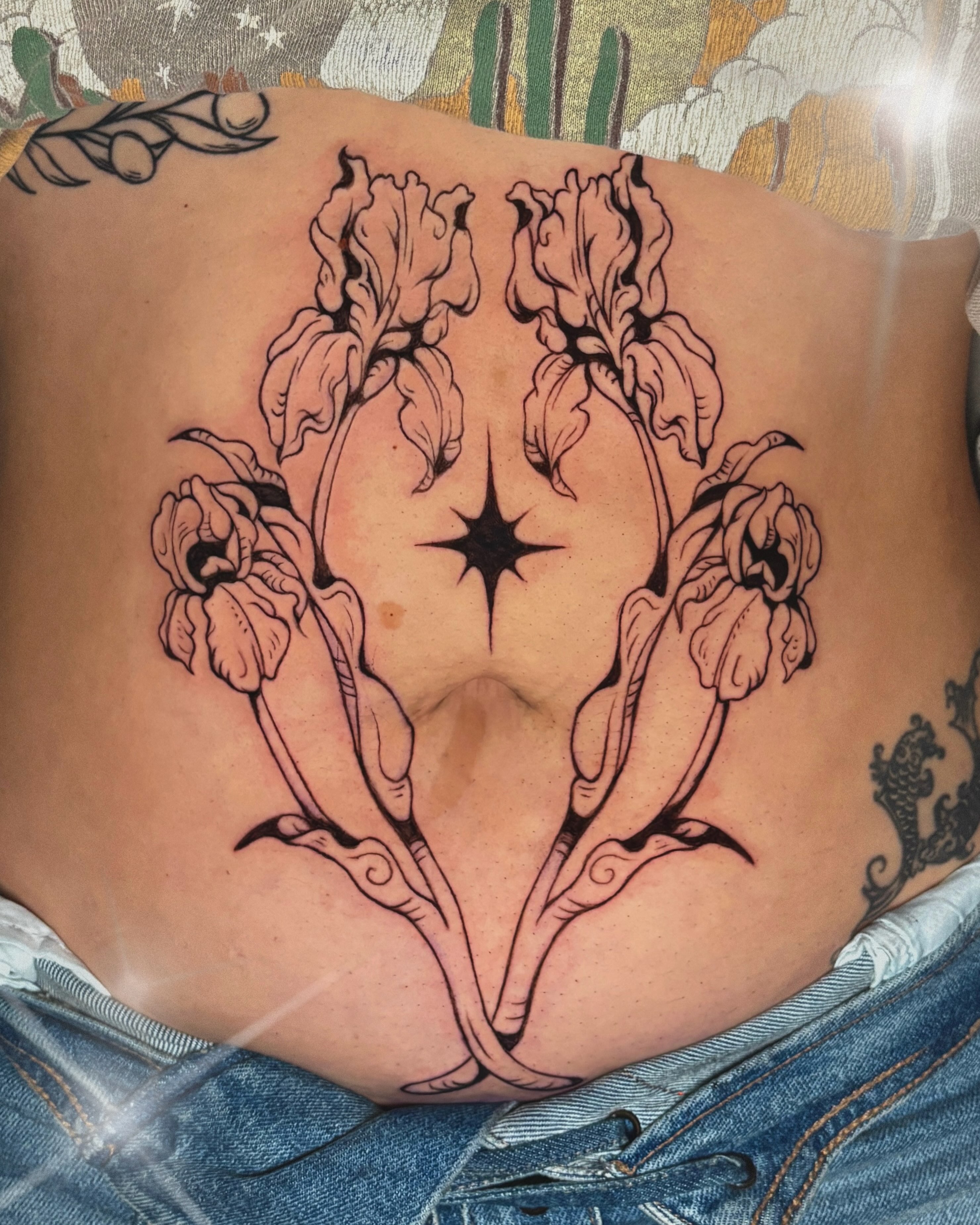 Iris flowers black and grey tattoo on the torso by Autumn