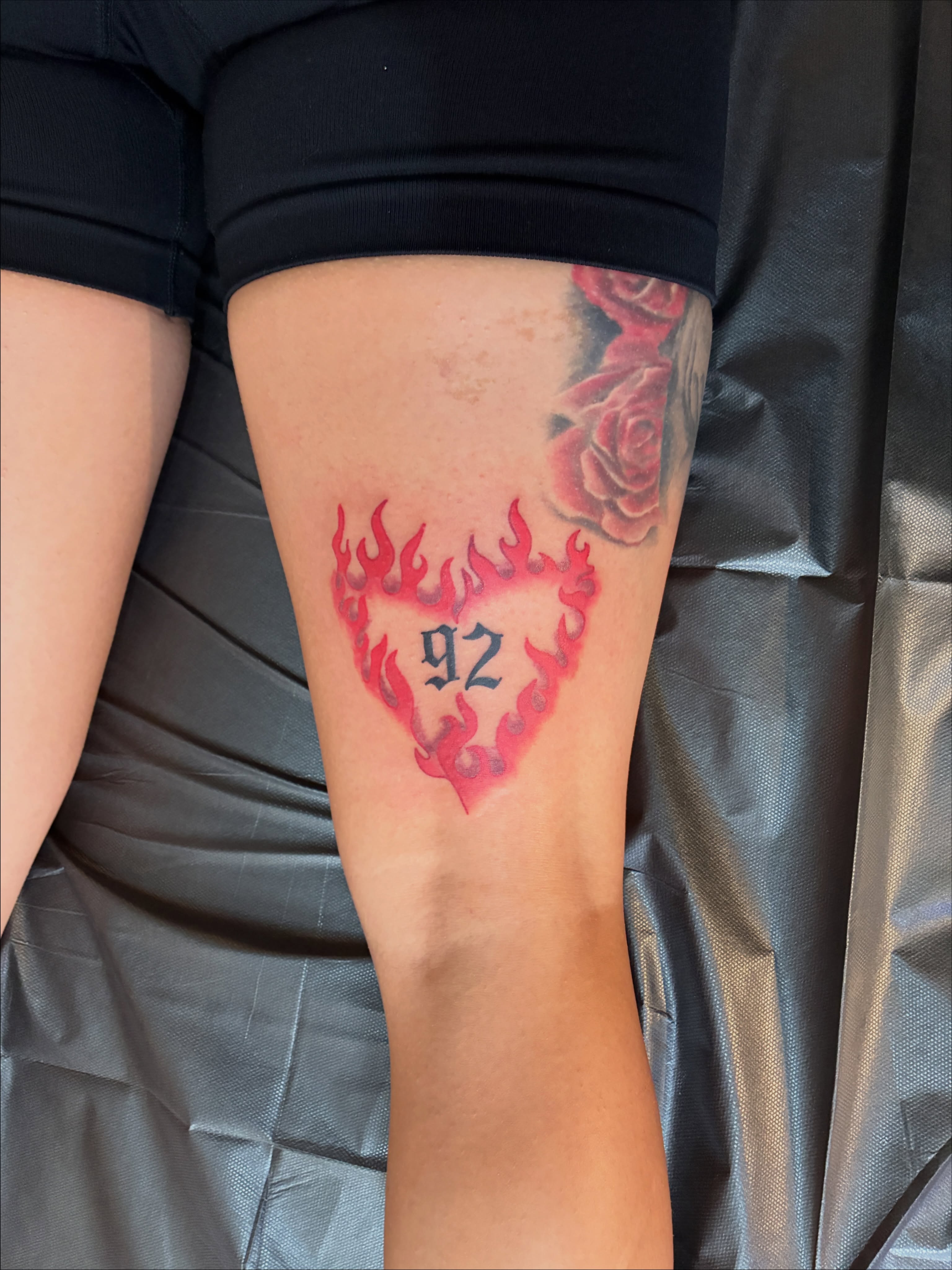 Flaming heart with '92 American traditional tattoo on the forearm by Seattle Tattoo Artist