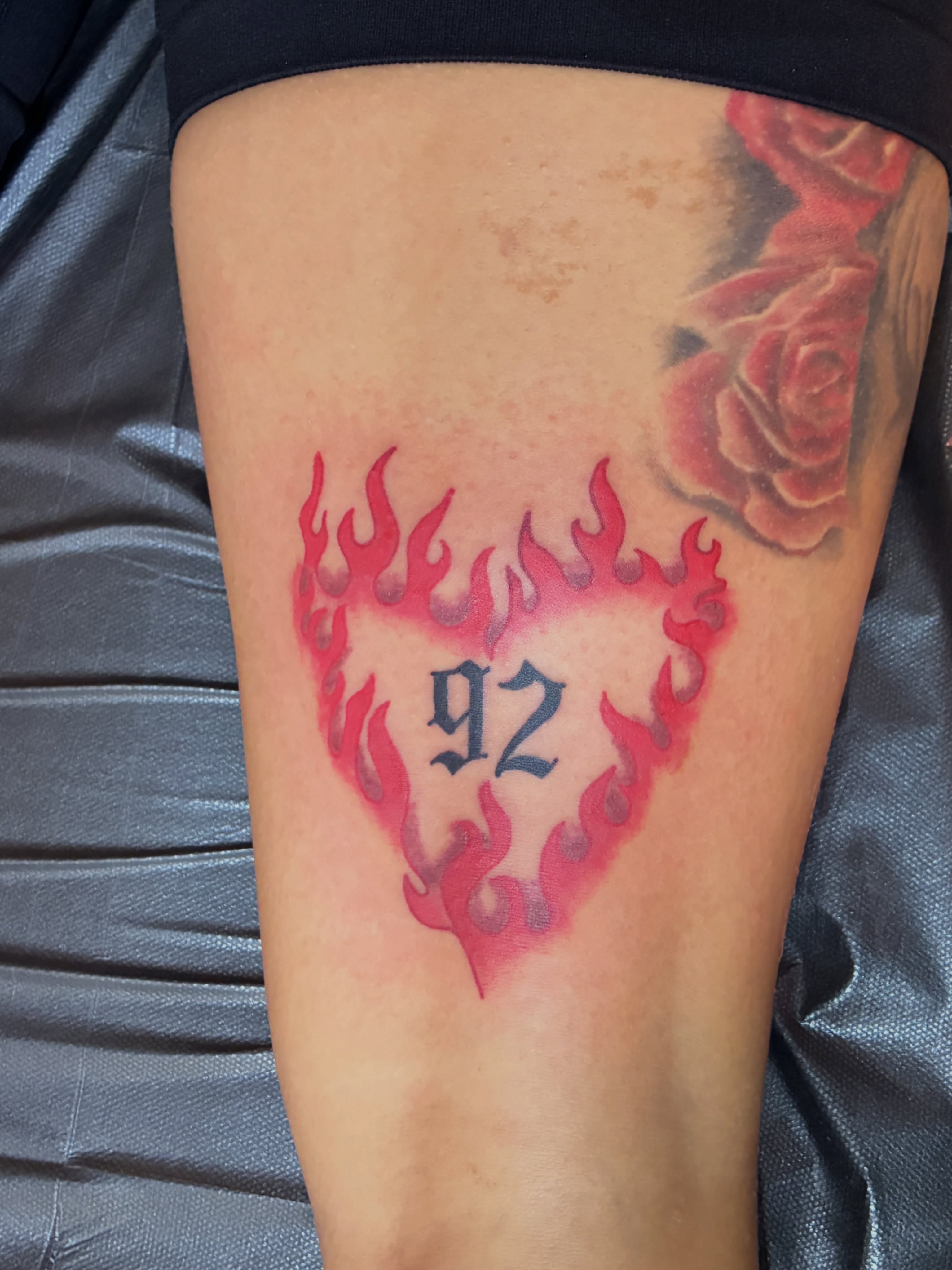 Flame heart with number 92 American traditional tattoo on the thigh by Seattle Tattoo Artist