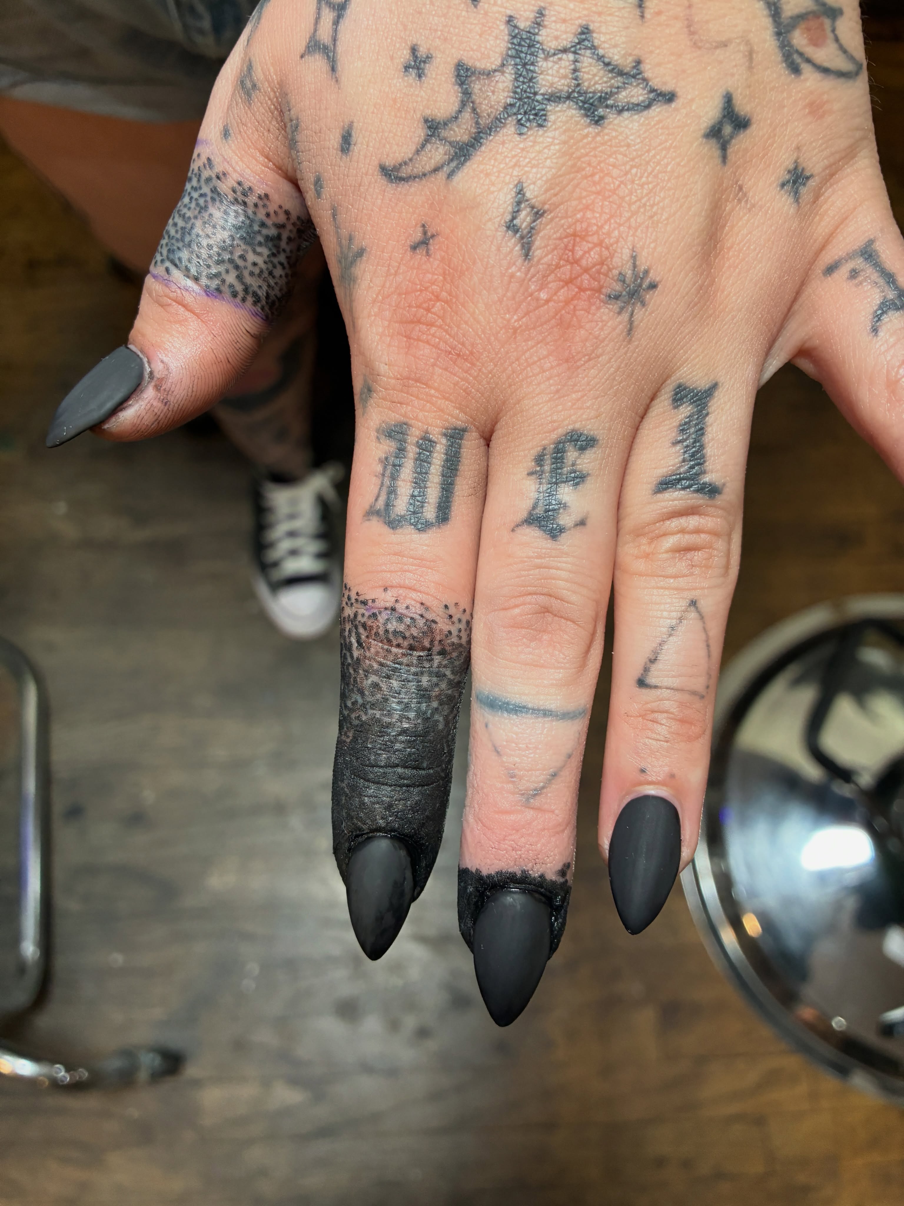Lettering dotwork tattoo on the hand by Seattle Tattoo Artist