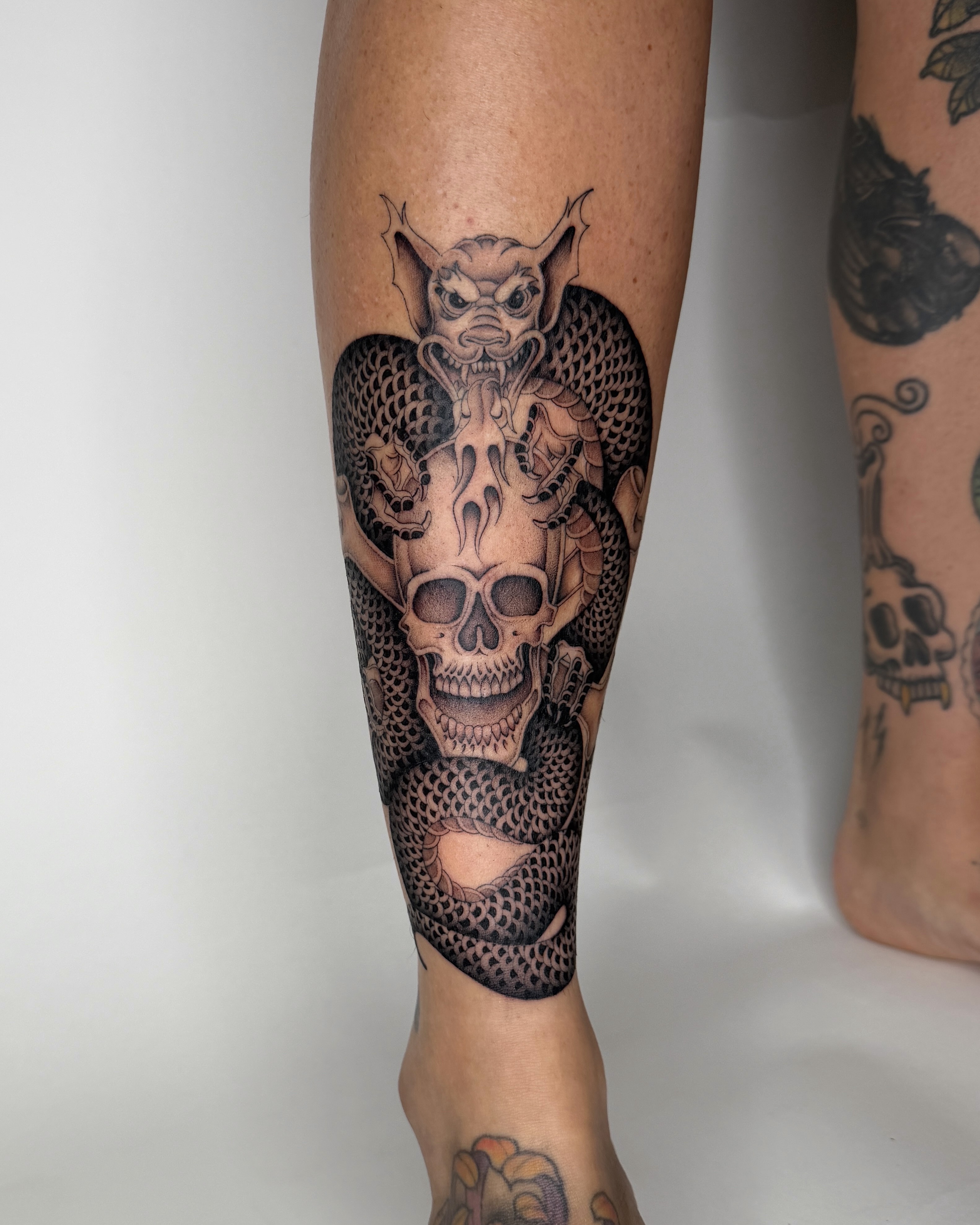Skull and dragon realism tattoo on the calf by IVY