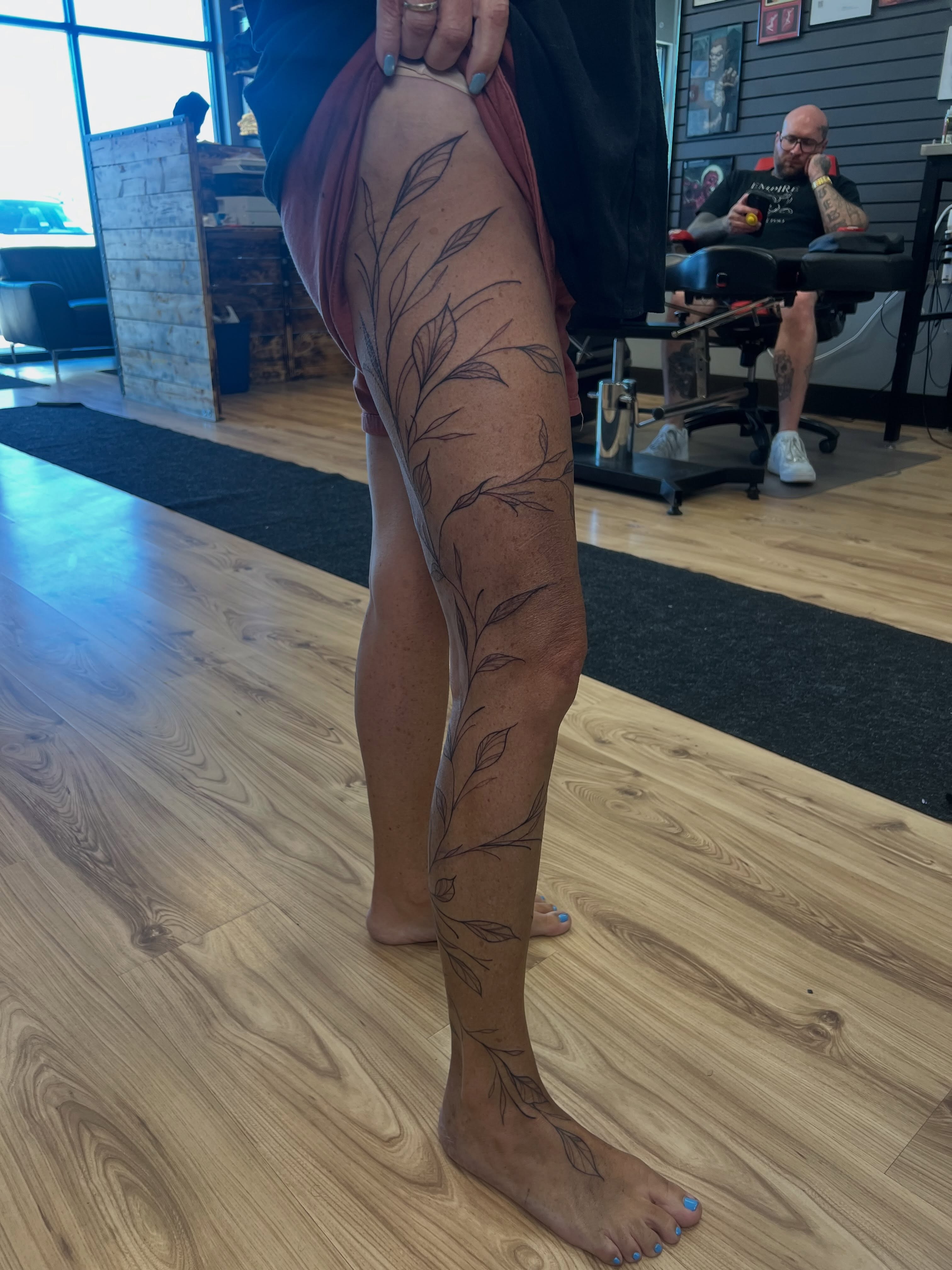 Leafy vine black and grey tattoo on the leg by Bailey Goodwin, Ankeny, Iowa