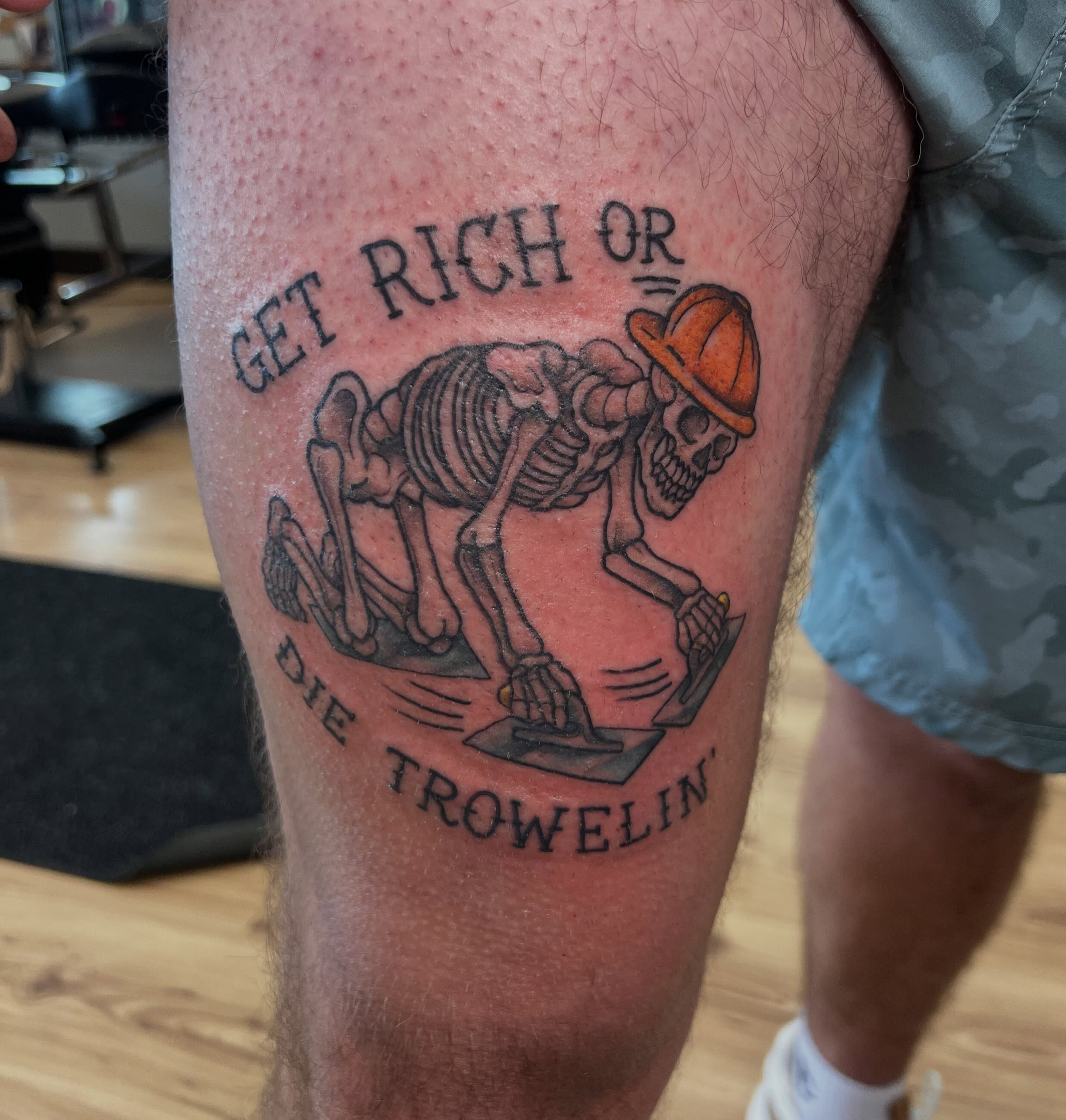 Skeleton troweling black and grey tattoo on the thigh by Bailey Goodwin, Ankeny, Iowa