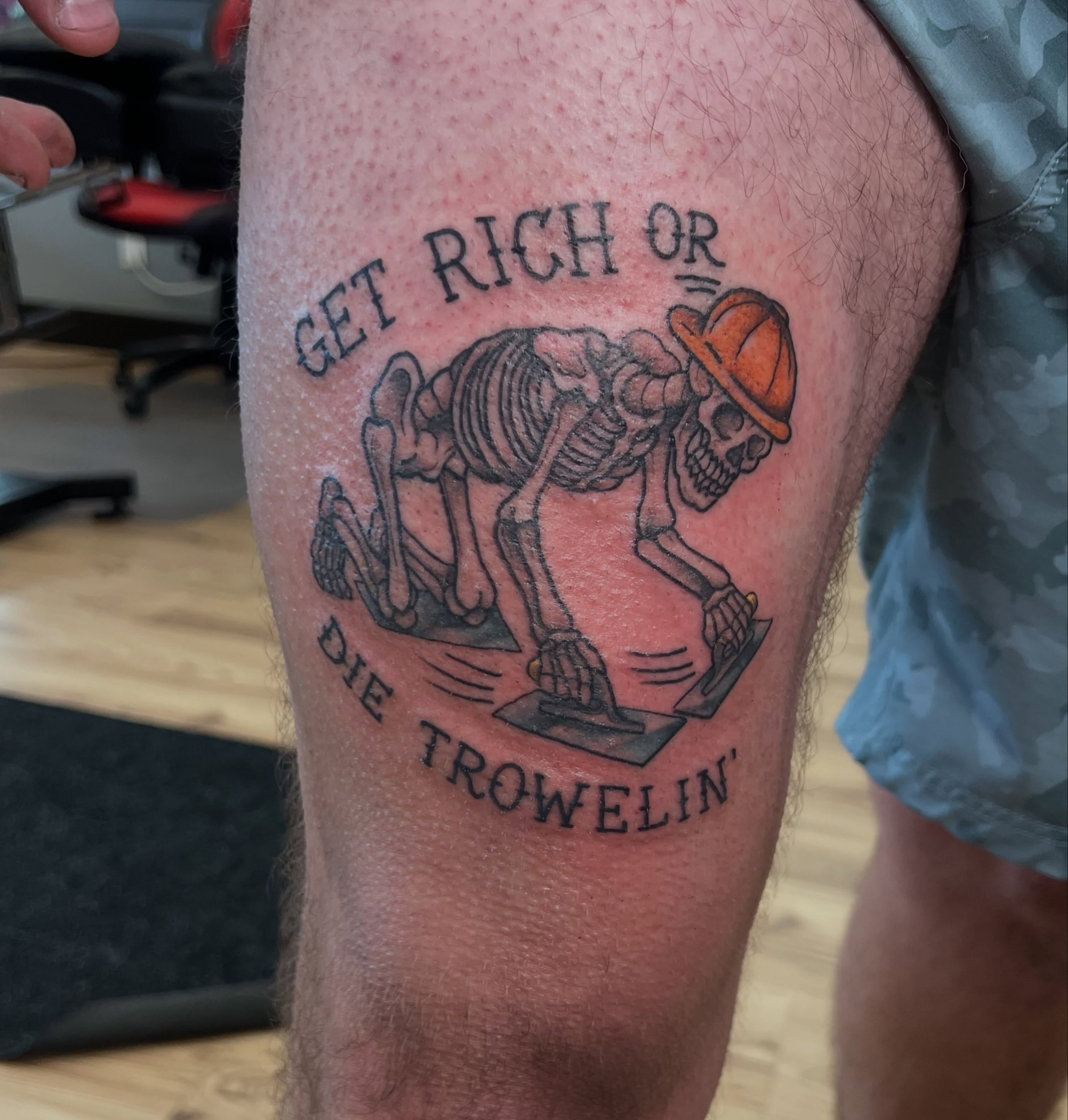 Skeleton troweling black and grey tattoo on the thigh by Bailey Goodwin, Ankeny, Iowa