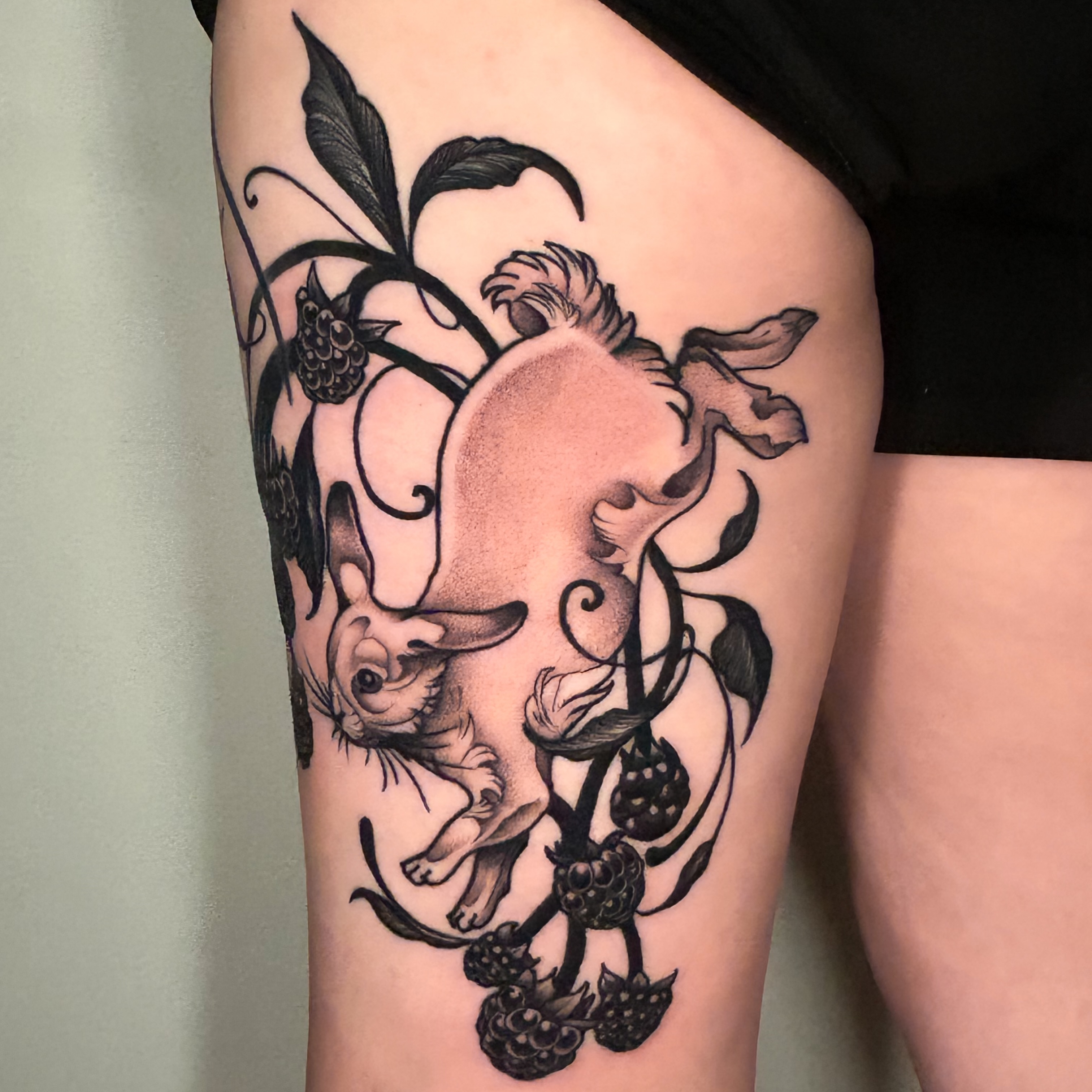 Cat and berries realism tattoo on the thigh by Crystal Thorns