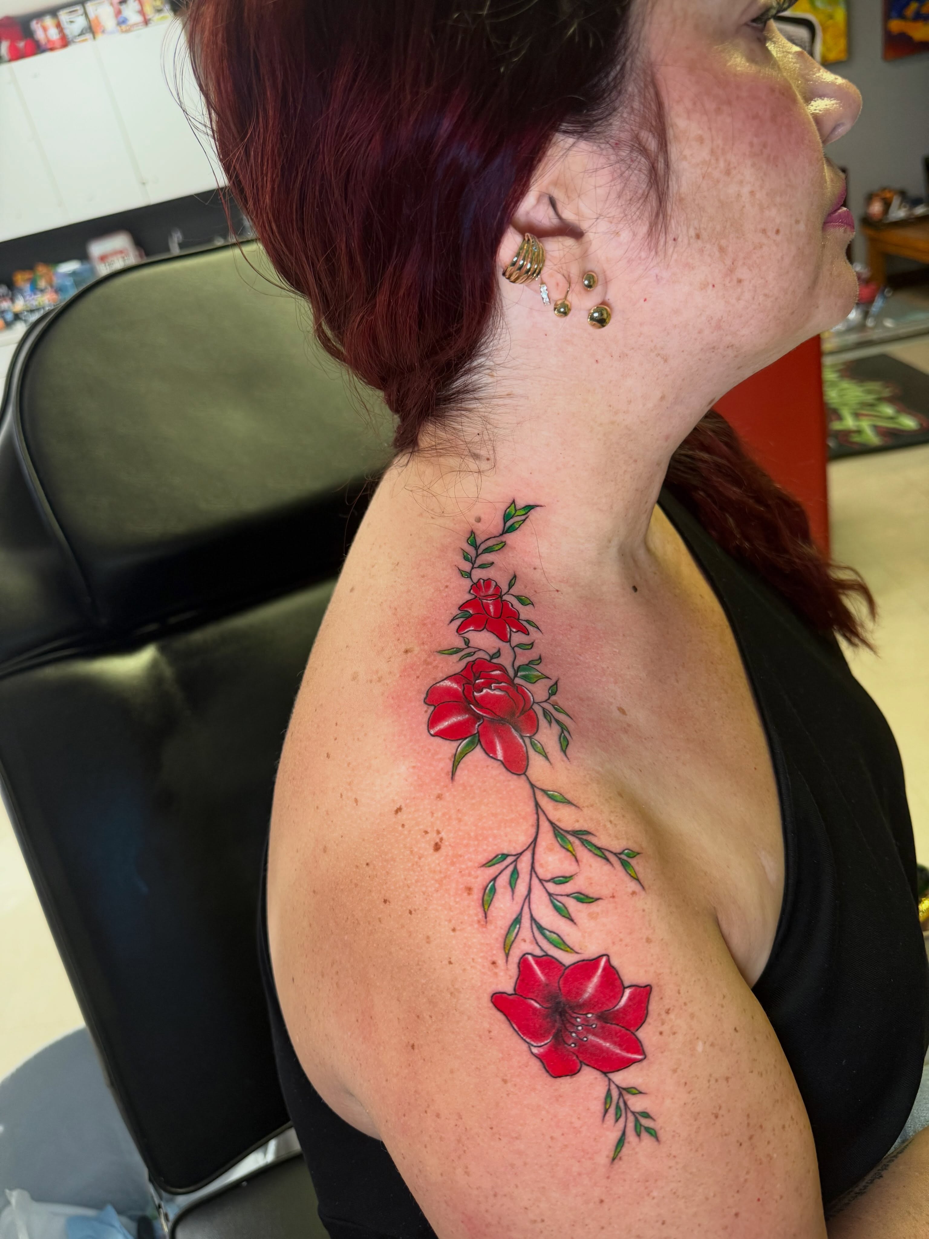 Red roses new school tattoo on the shoulder by Steve - Tattoo Artist