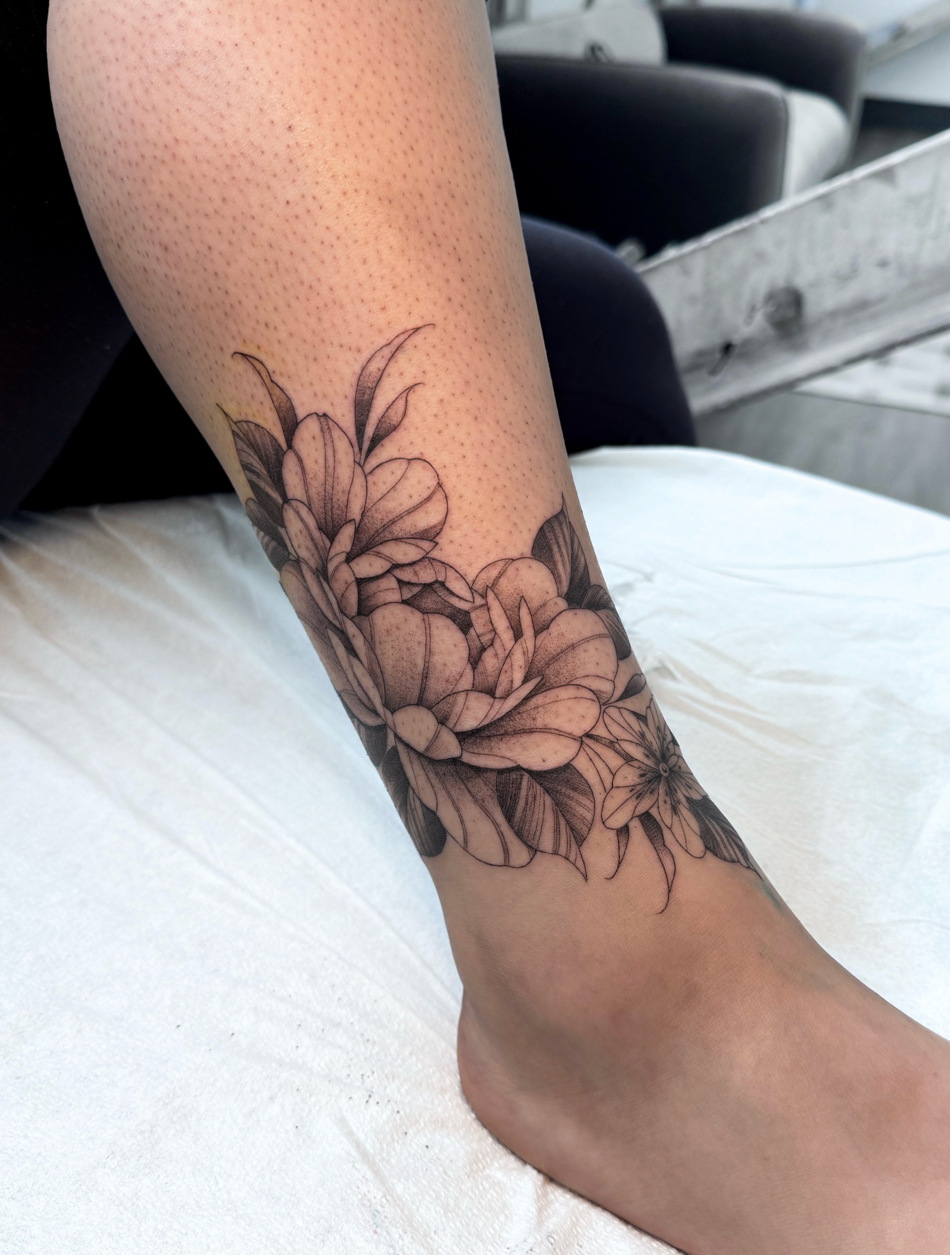 Floral arrangement black and grey tattoo on the forearm by @nudylicioustattoos