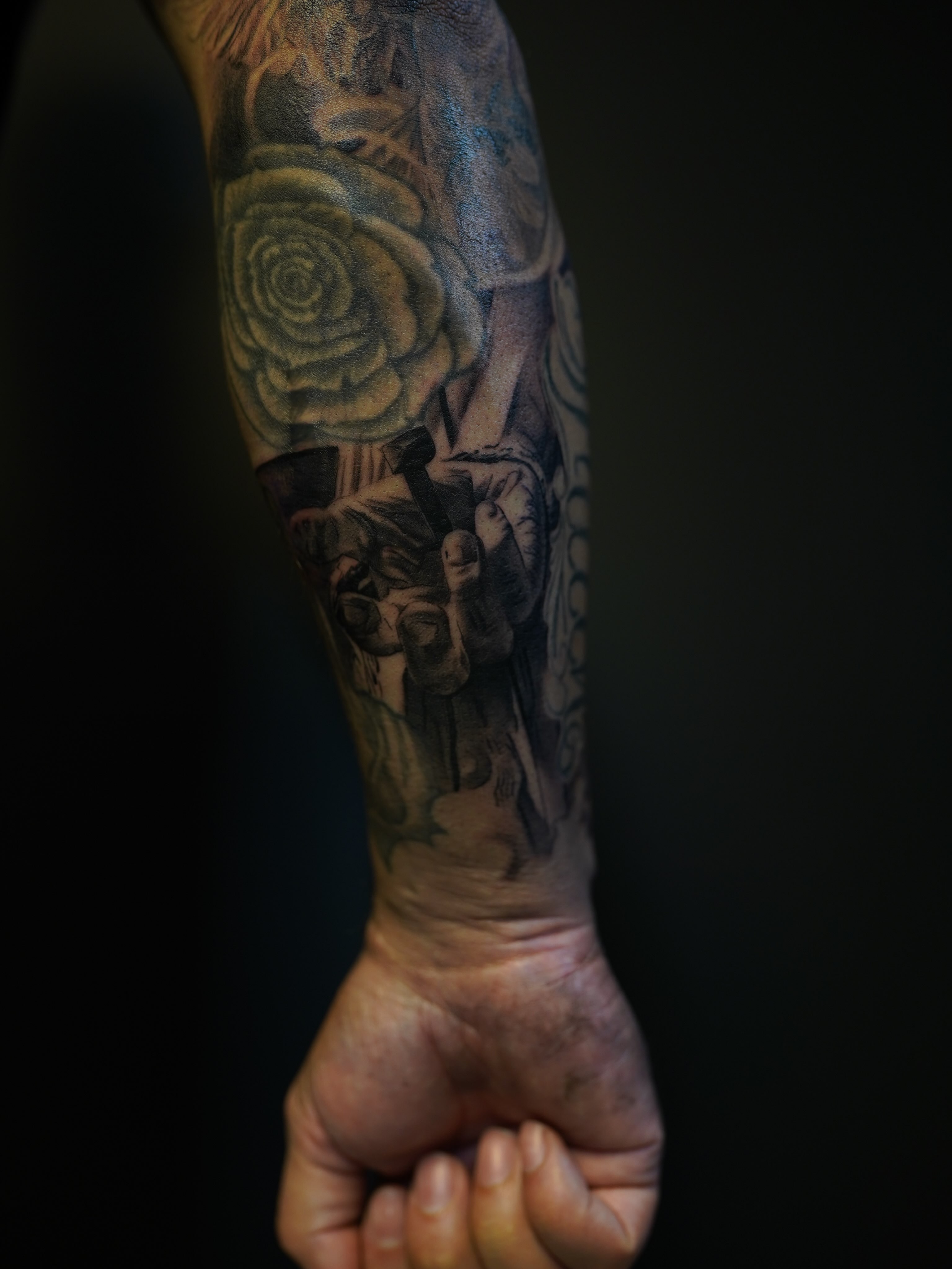 Rose and skull realism tattoo on the forearm by Eric RudeInk