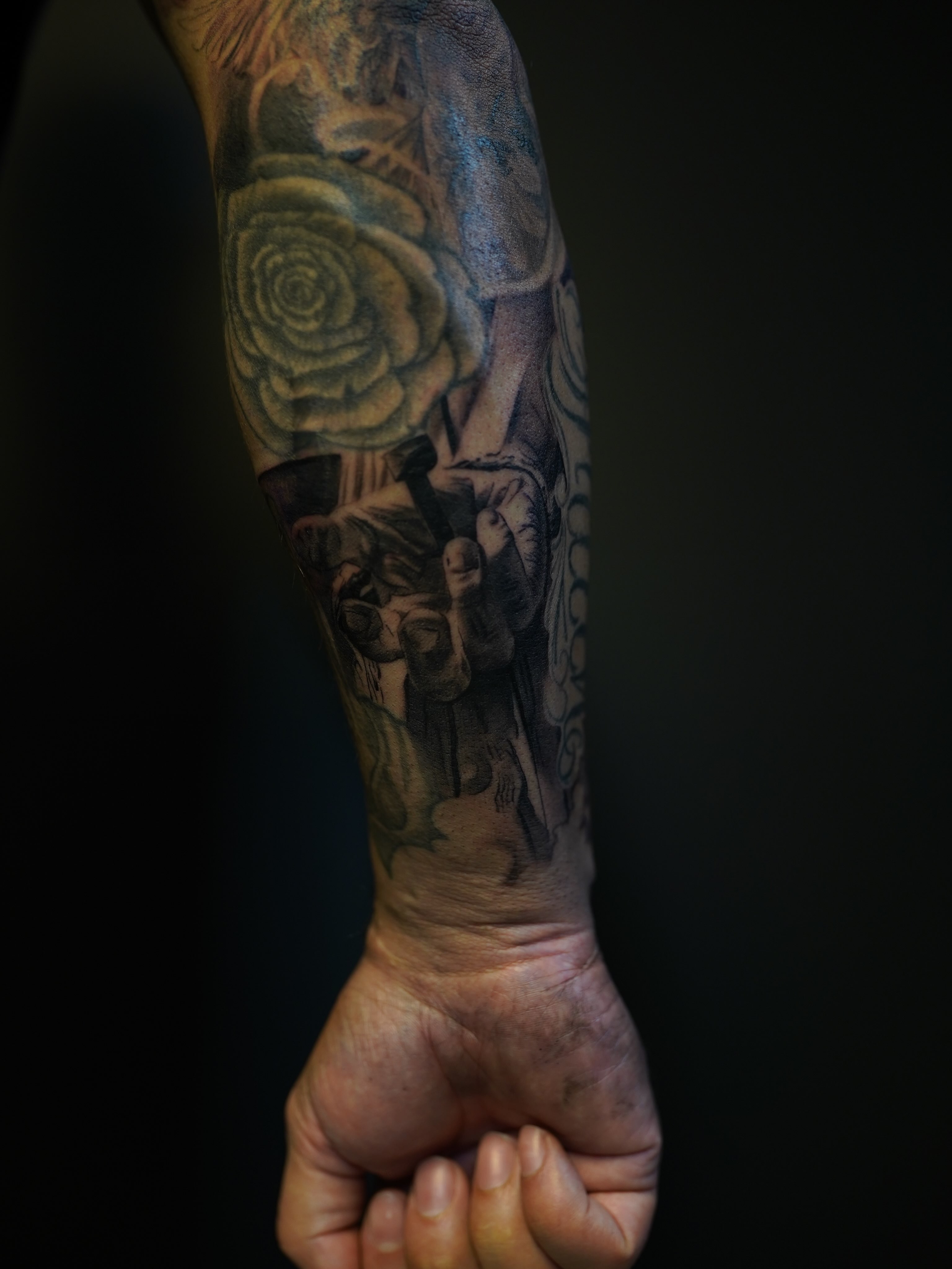 Rose and skull realism tattoo on the forearm by Eric RudeInk