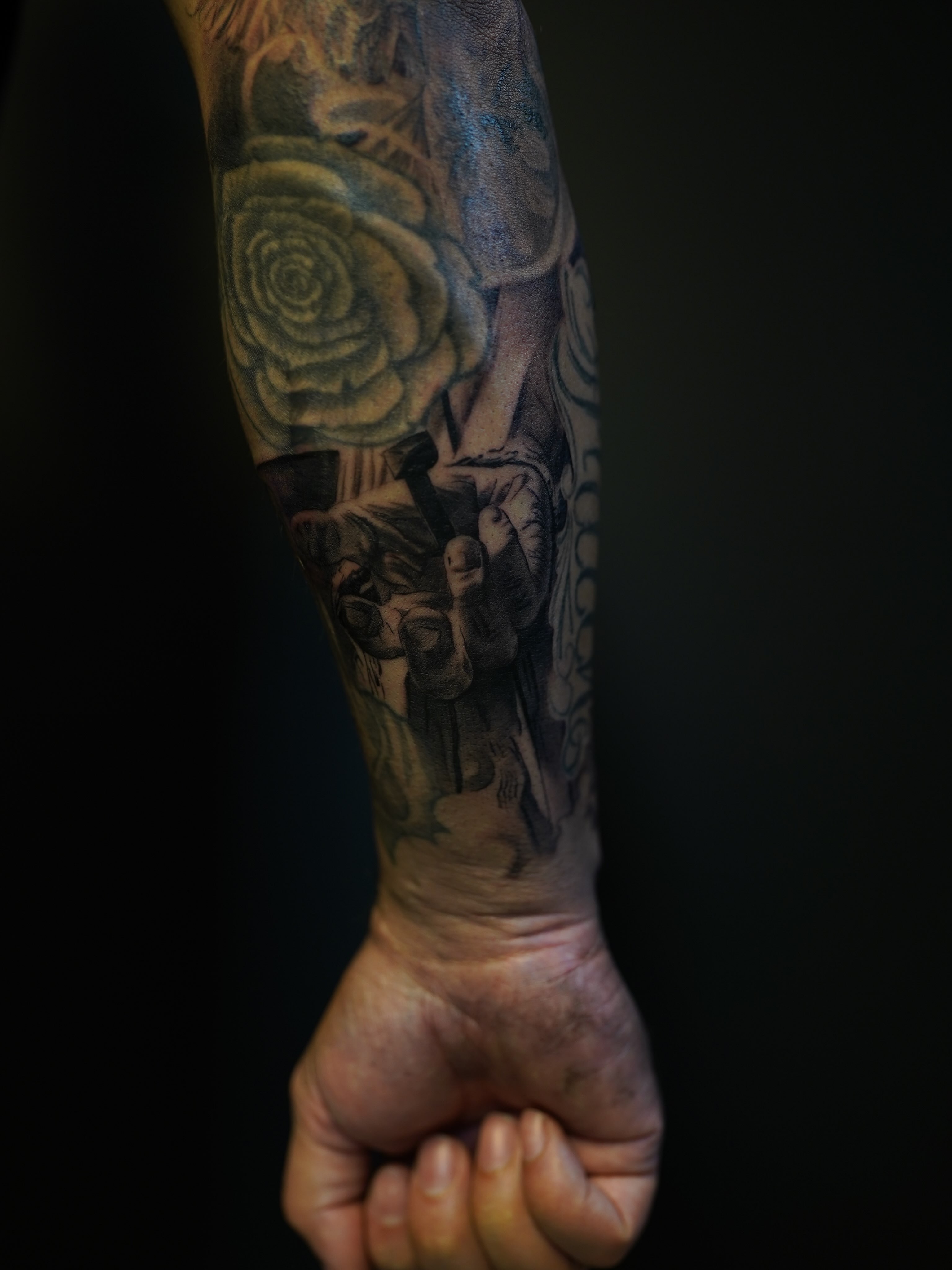 Rose and skull realism tattoo on the forearm by Eric RudeInk