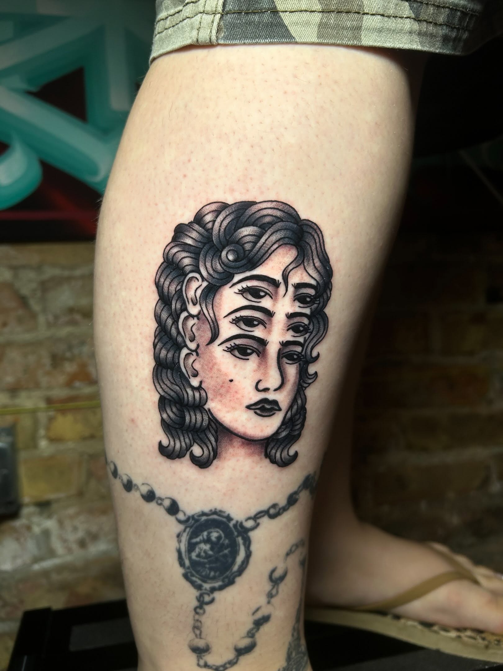 Woman's head black and grey tattoo on the thigh by Alycia