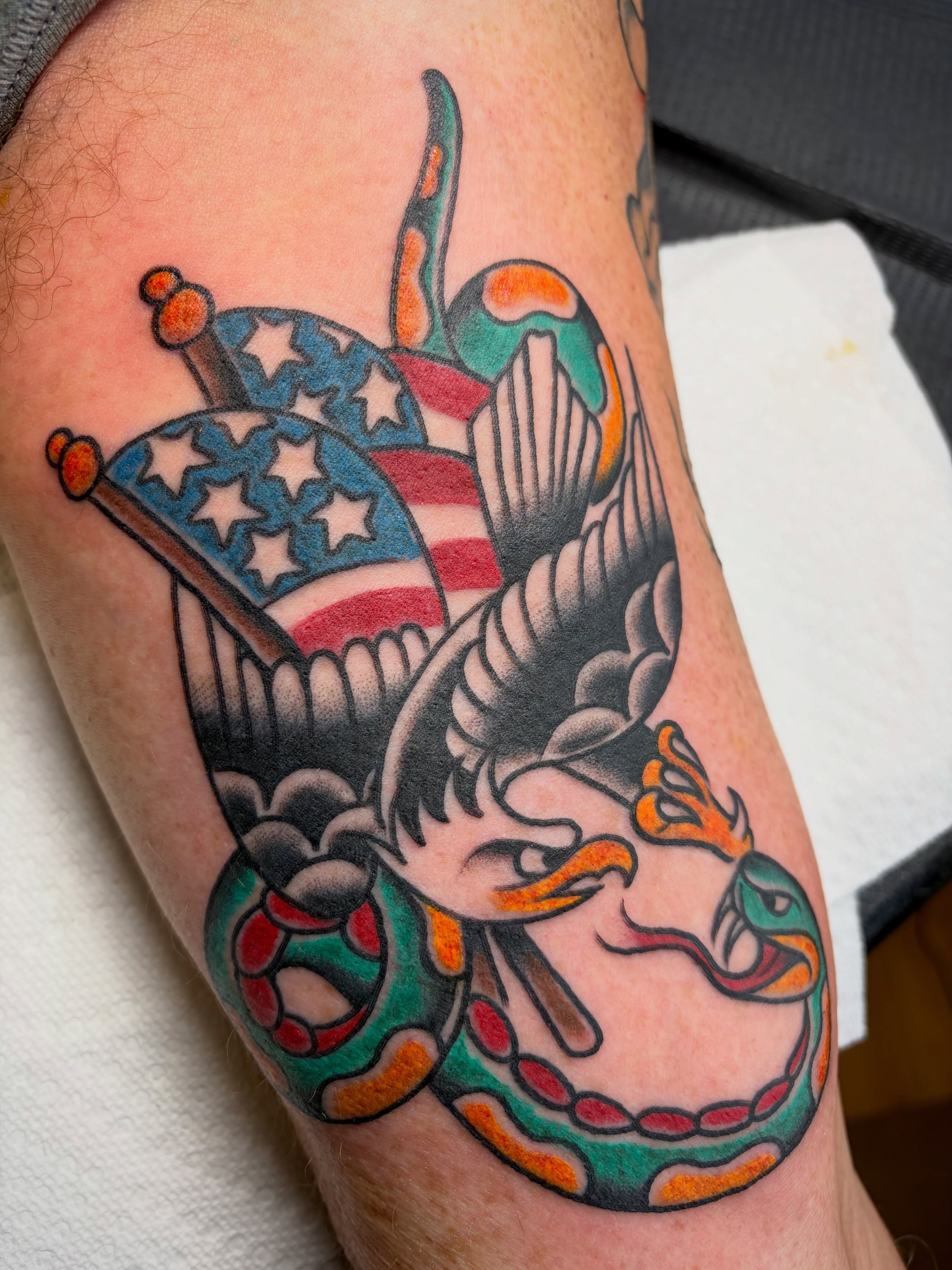 Eagle and snake American traditional tattoo on the forearm by Micheal McGlinchey