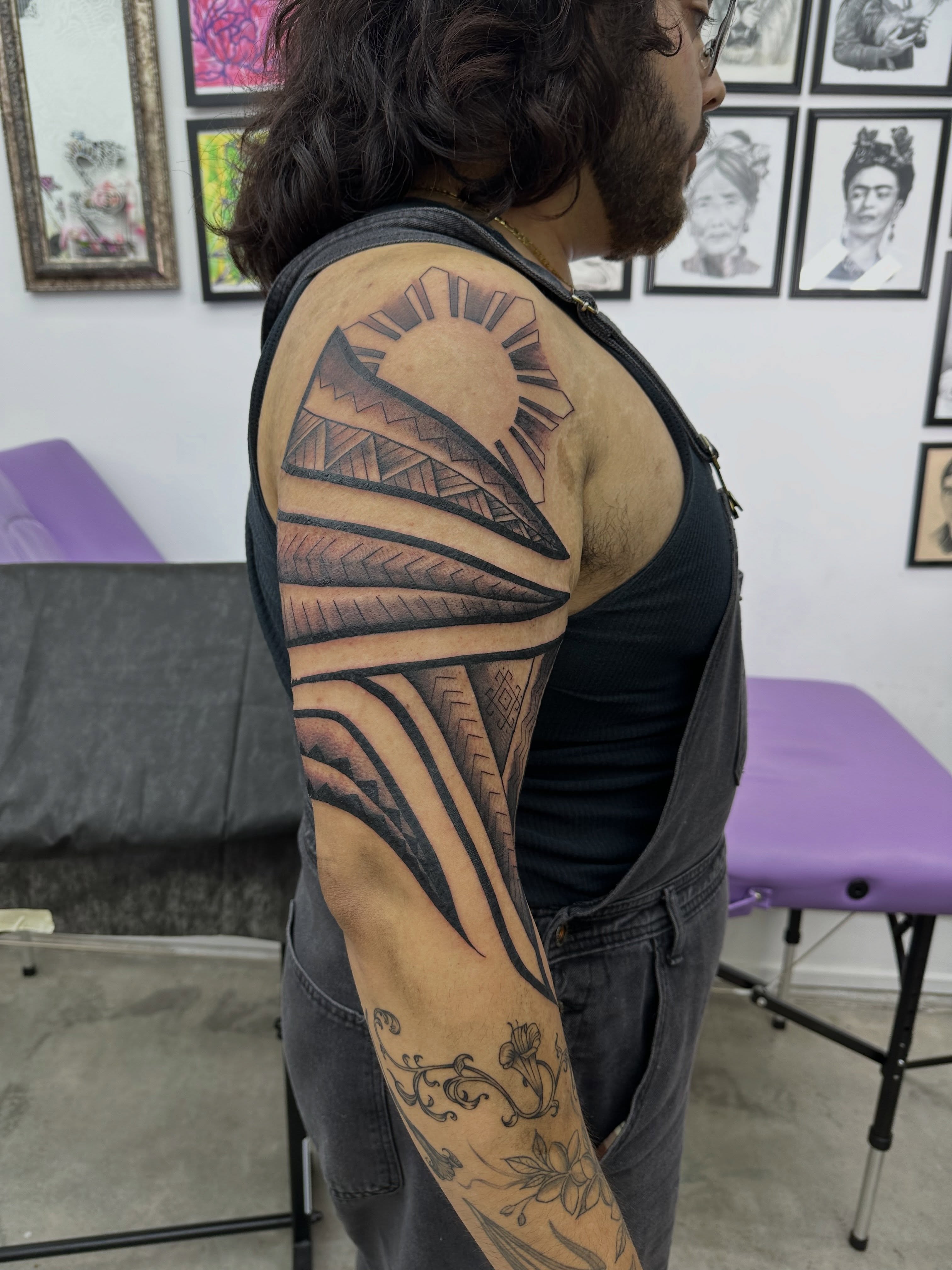 Tribal sun tribal tattoo on the upper arm by Nate Webb