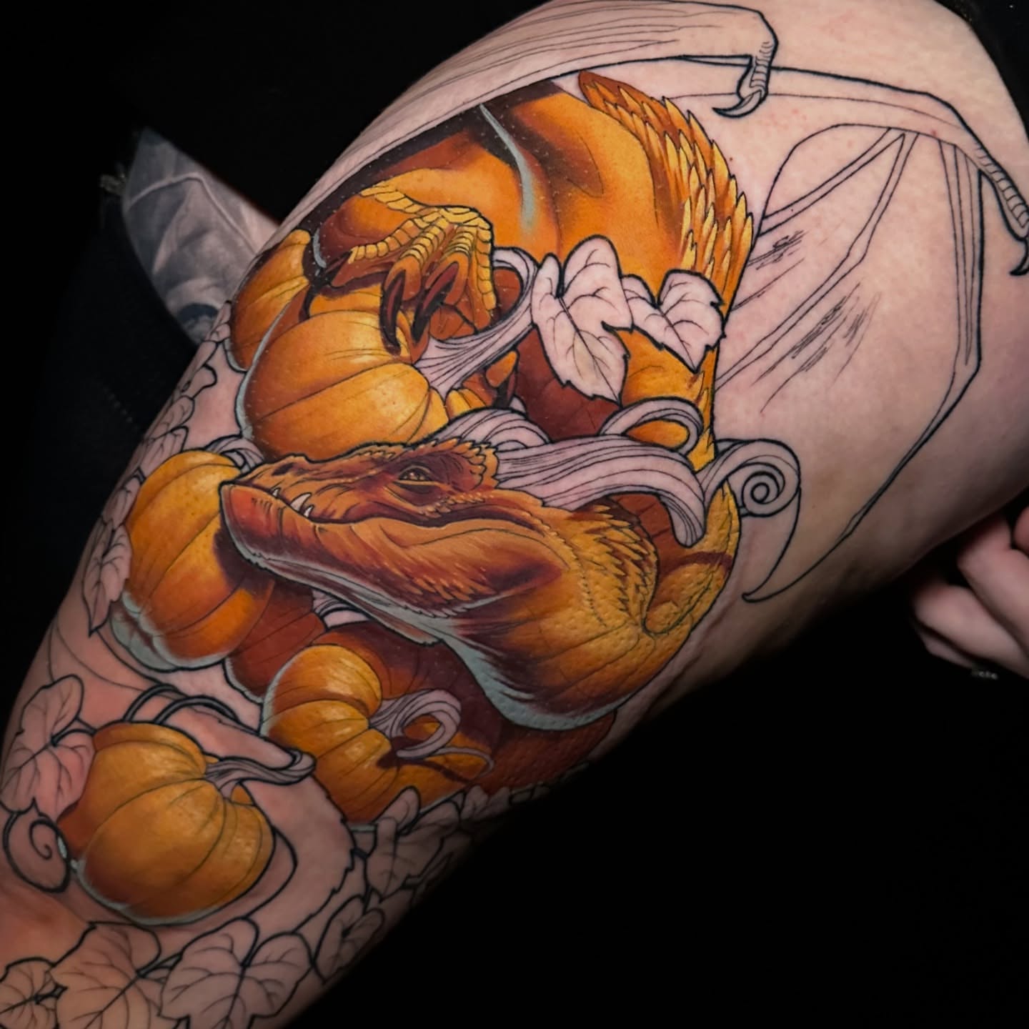 Pumpkin dragon realism tattoo on the upper arm by Breah Beshore Kirk