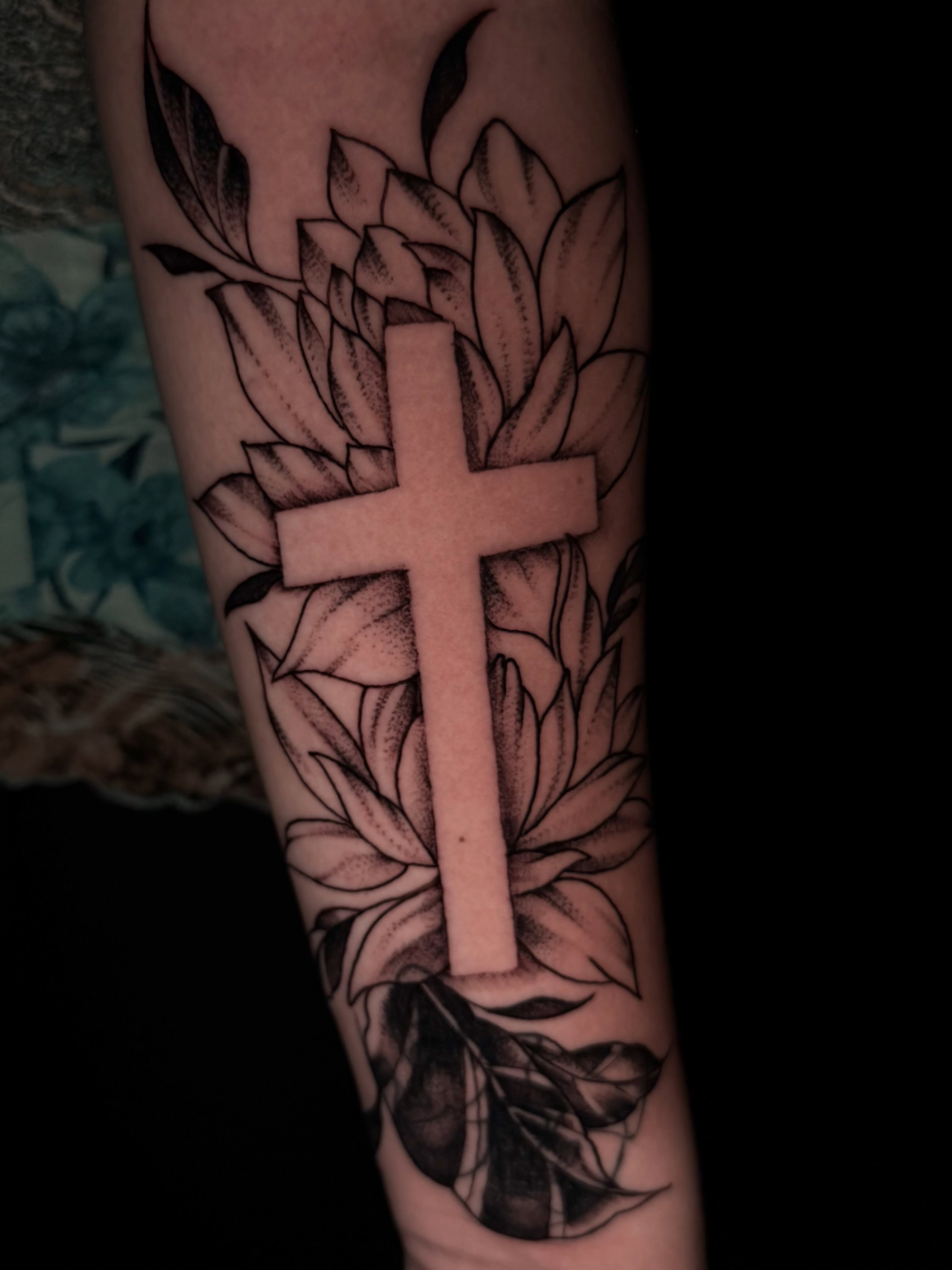 Cross with floral background black and grey tattoo on the forearm by Exploitedtattoos
