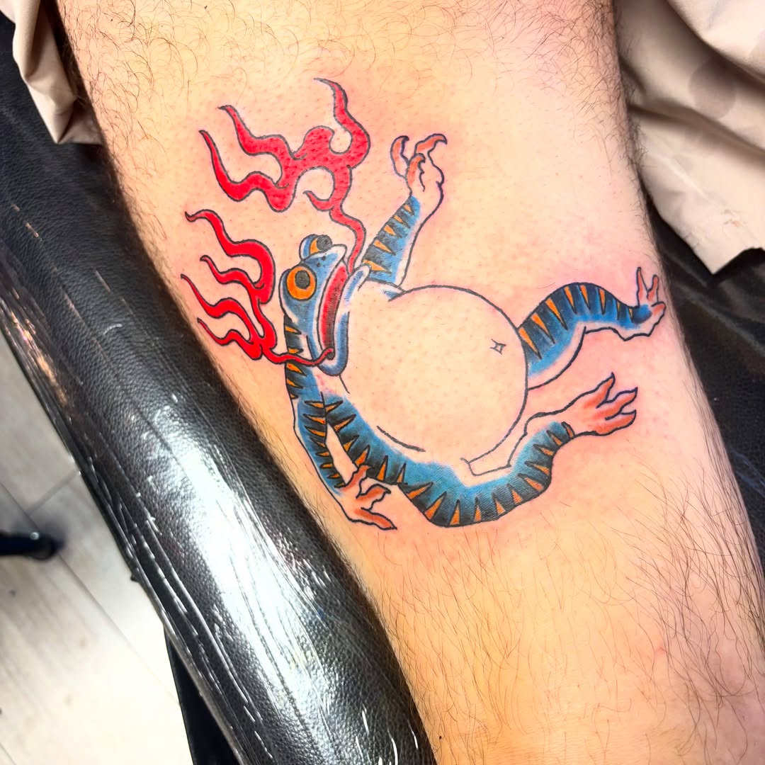 Fire-breathing dragon American traditional tattoo on the thigh by Landon Bagley