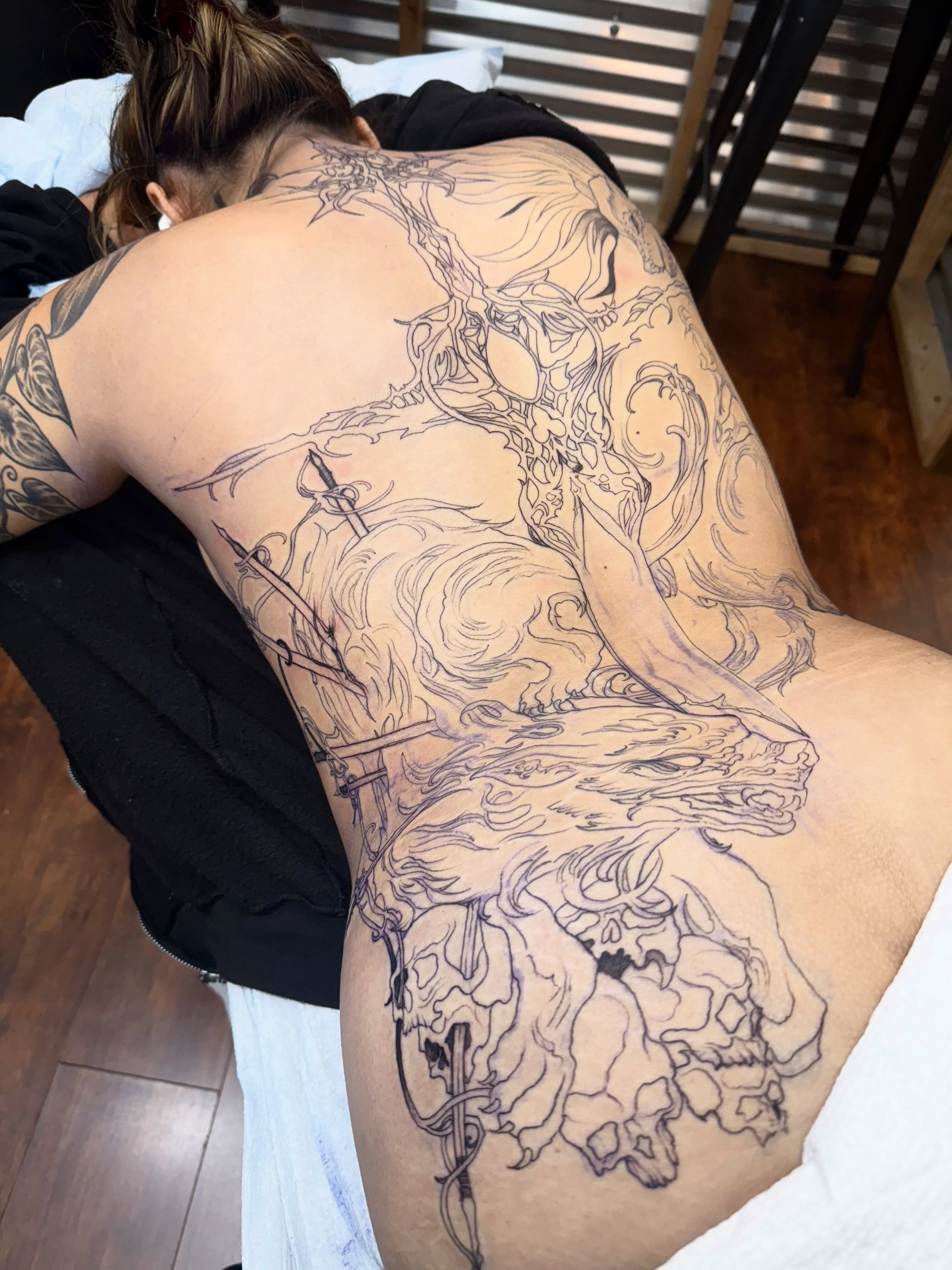 Mythical creature black and grey tattoo on the back by Isabella π€