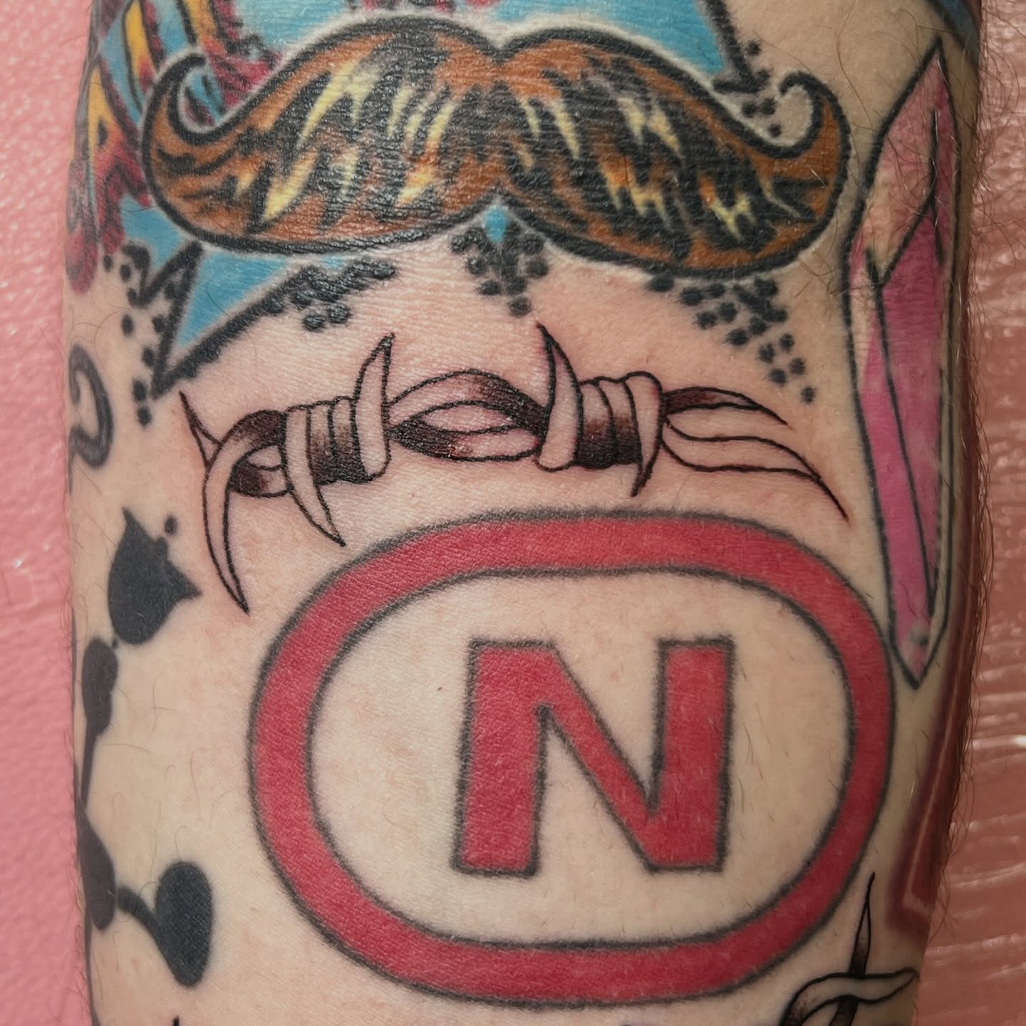 Mustache and teeth American traditional tattoo on the forearm by Tomfoolery