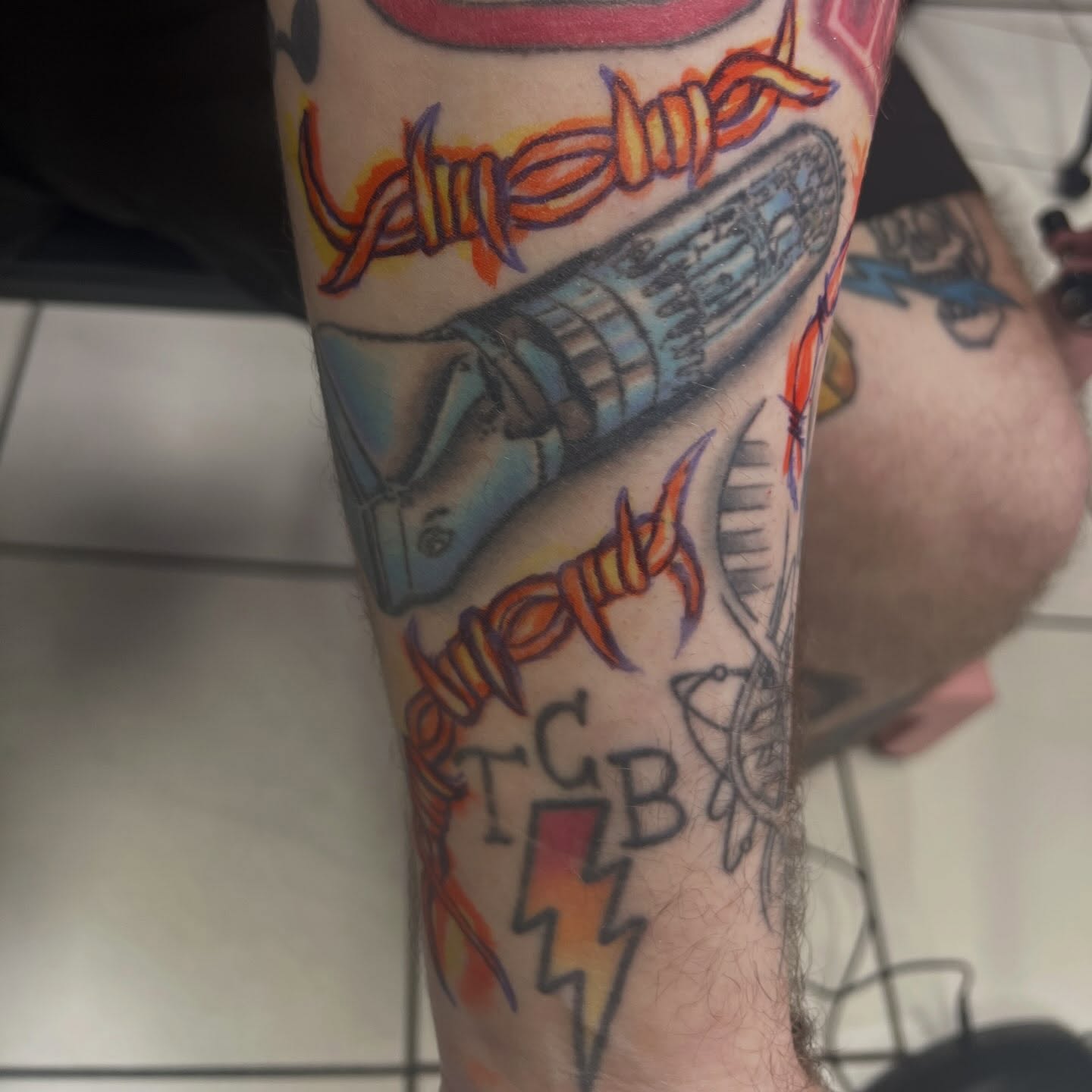 Barbed wire and rocket American traditional tattoo on the forearm by Tomfoolery