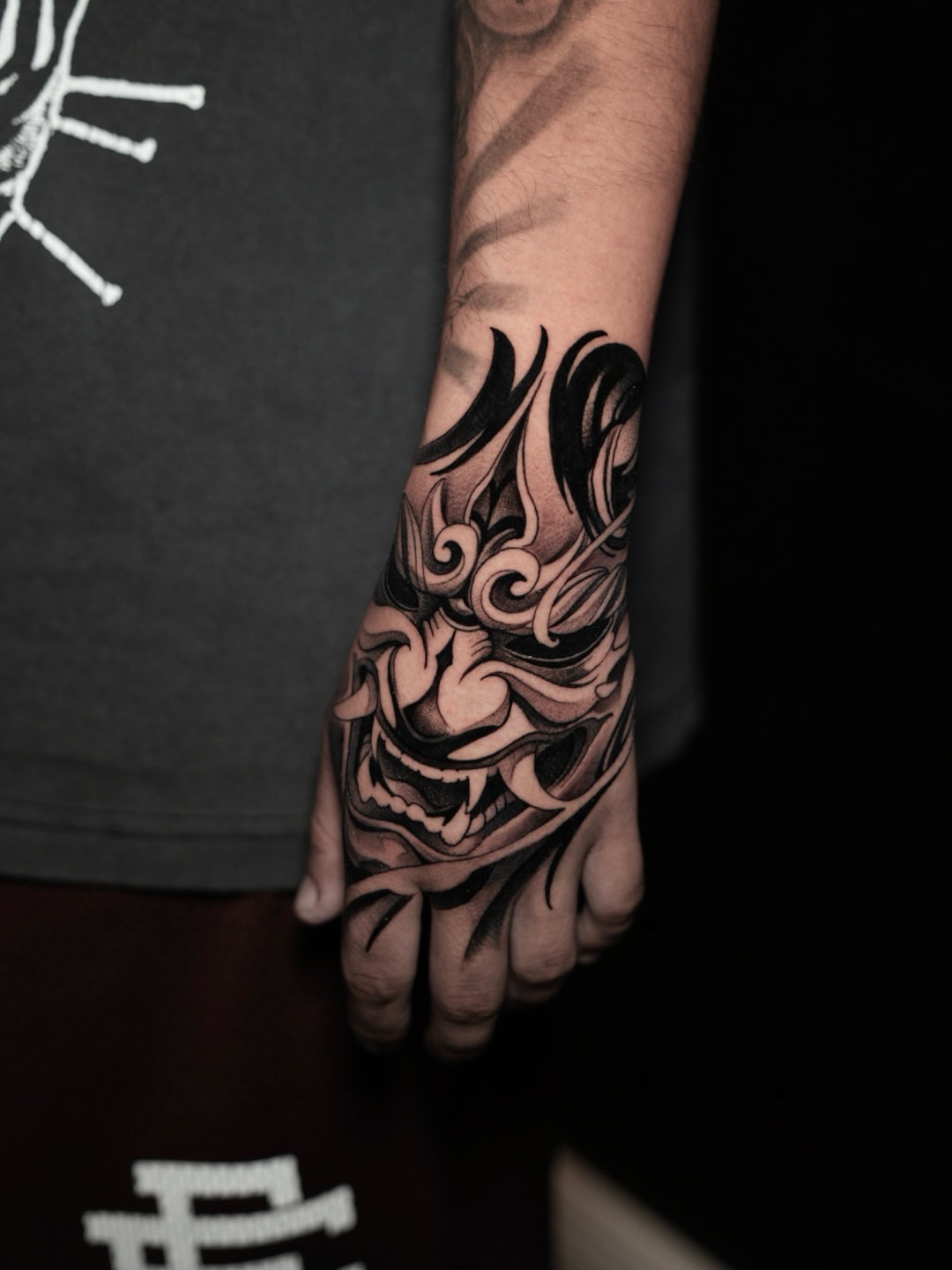 Mask black and grey tattoo on the hand by CRISTIAN AMORES シ