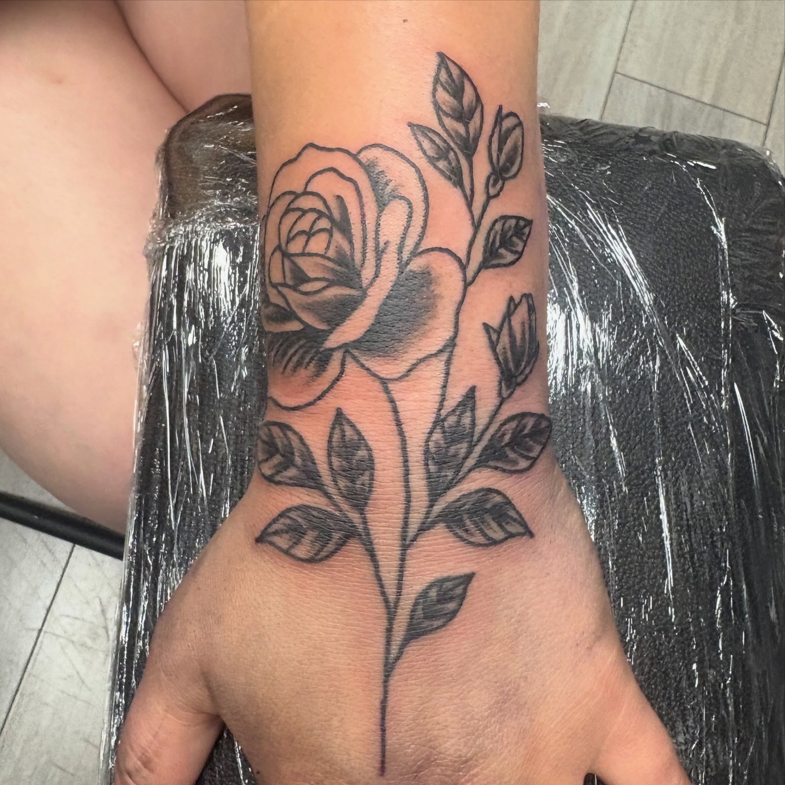 Rose black and grey tattoo on the forearm by Landon Bagley
