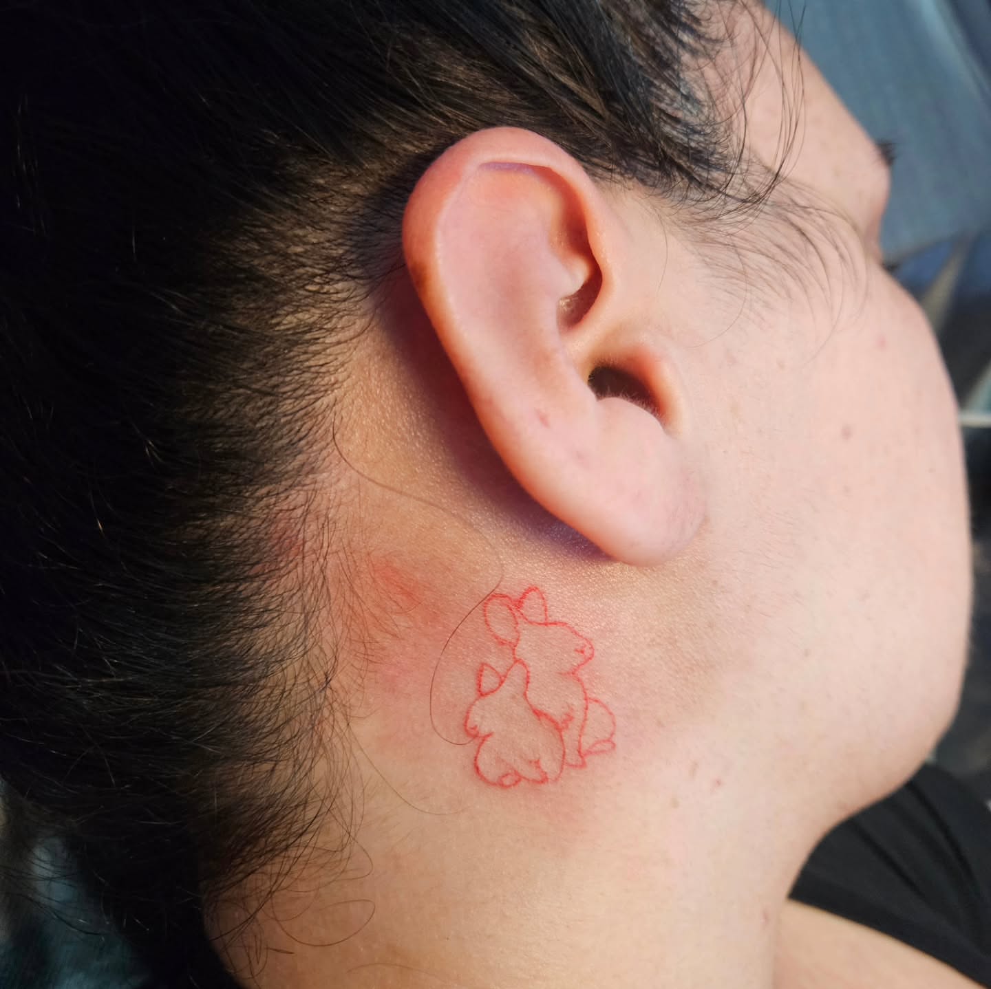 Rabbit minimalist tattoo on the neck by Mischief π€