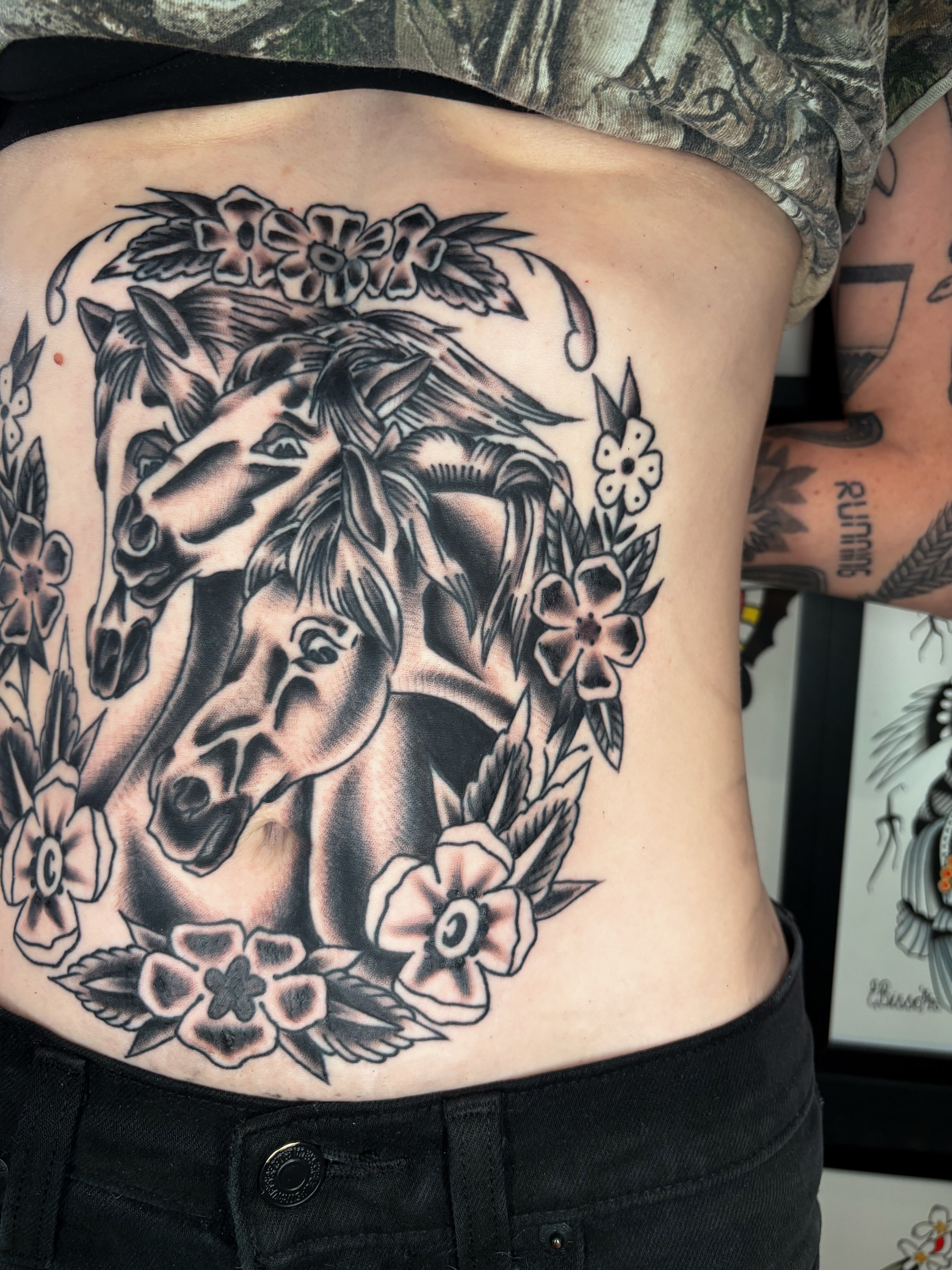 Horses and flowers American traditional tattoo on the ribs by Evan Bisso, Philadelphia, Pennsylvania