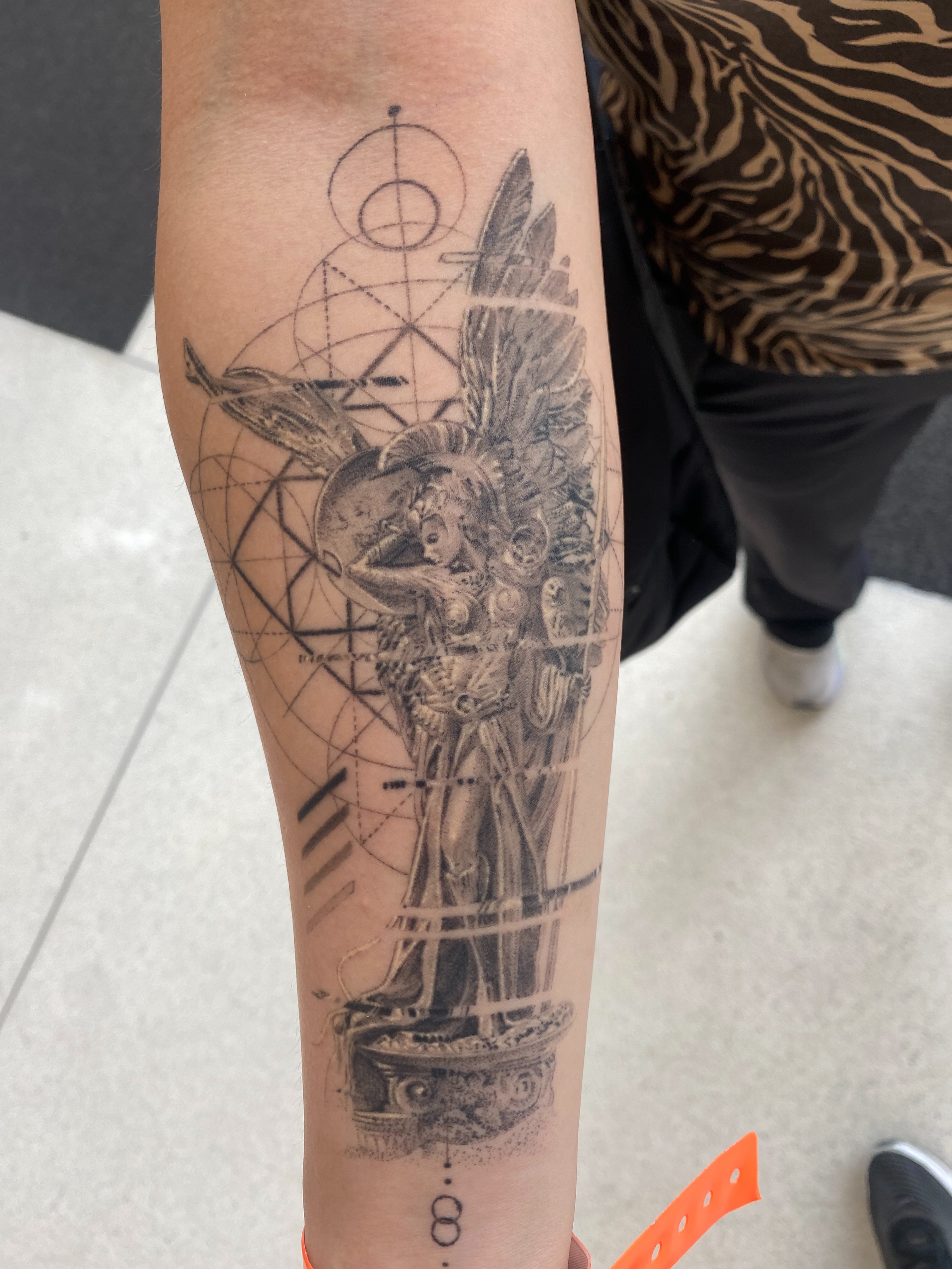 Statue with wings realism tattoo on the forearm by Dan Sprague