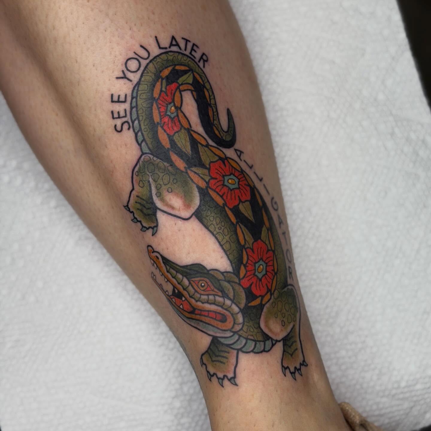 Alligator and flowers American traditional tattoo on the forearm by Jenna Szerszen-Wynn ๐