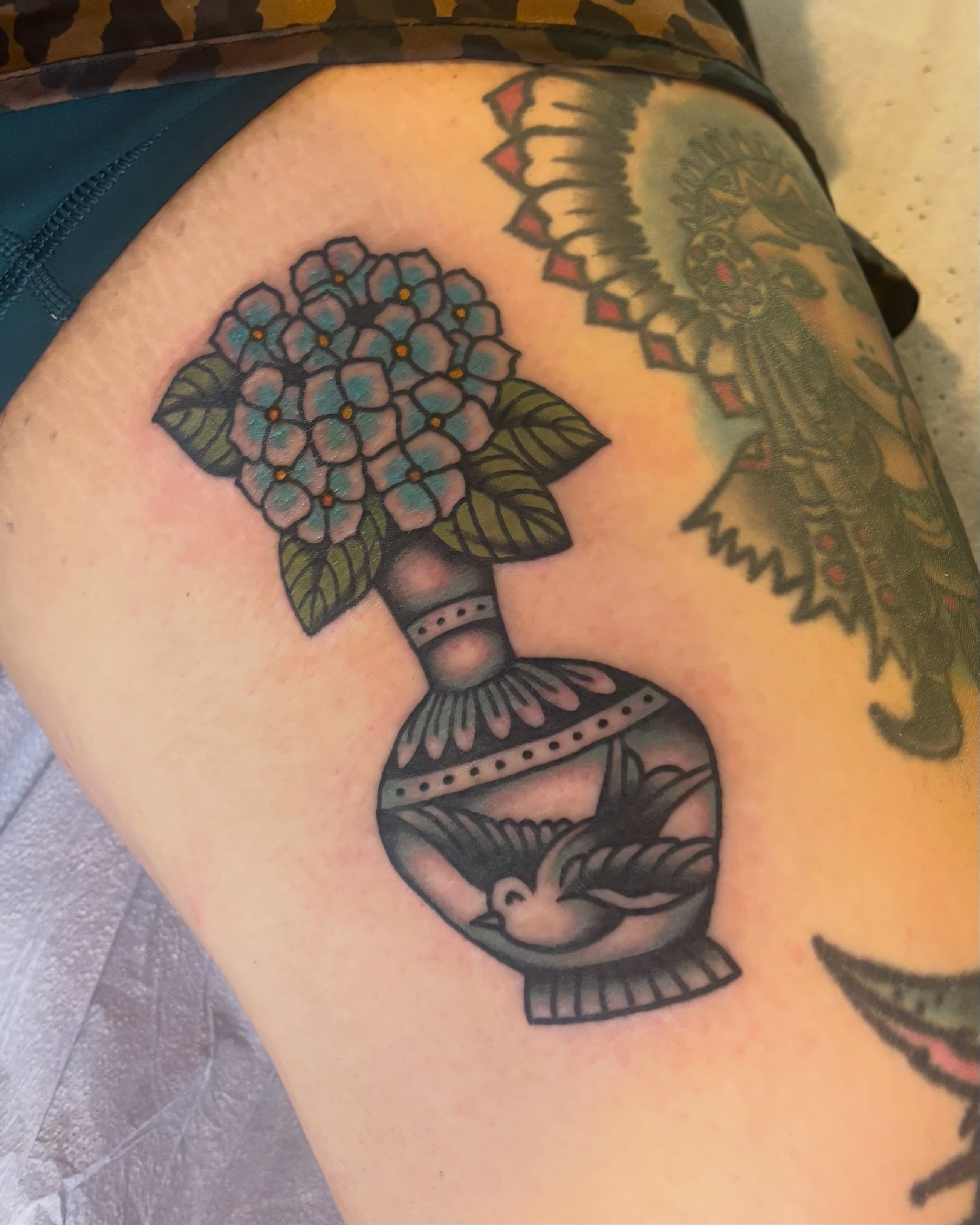 Hydrangea bouquet American traditional tattoo on the thigh by Tia Cave