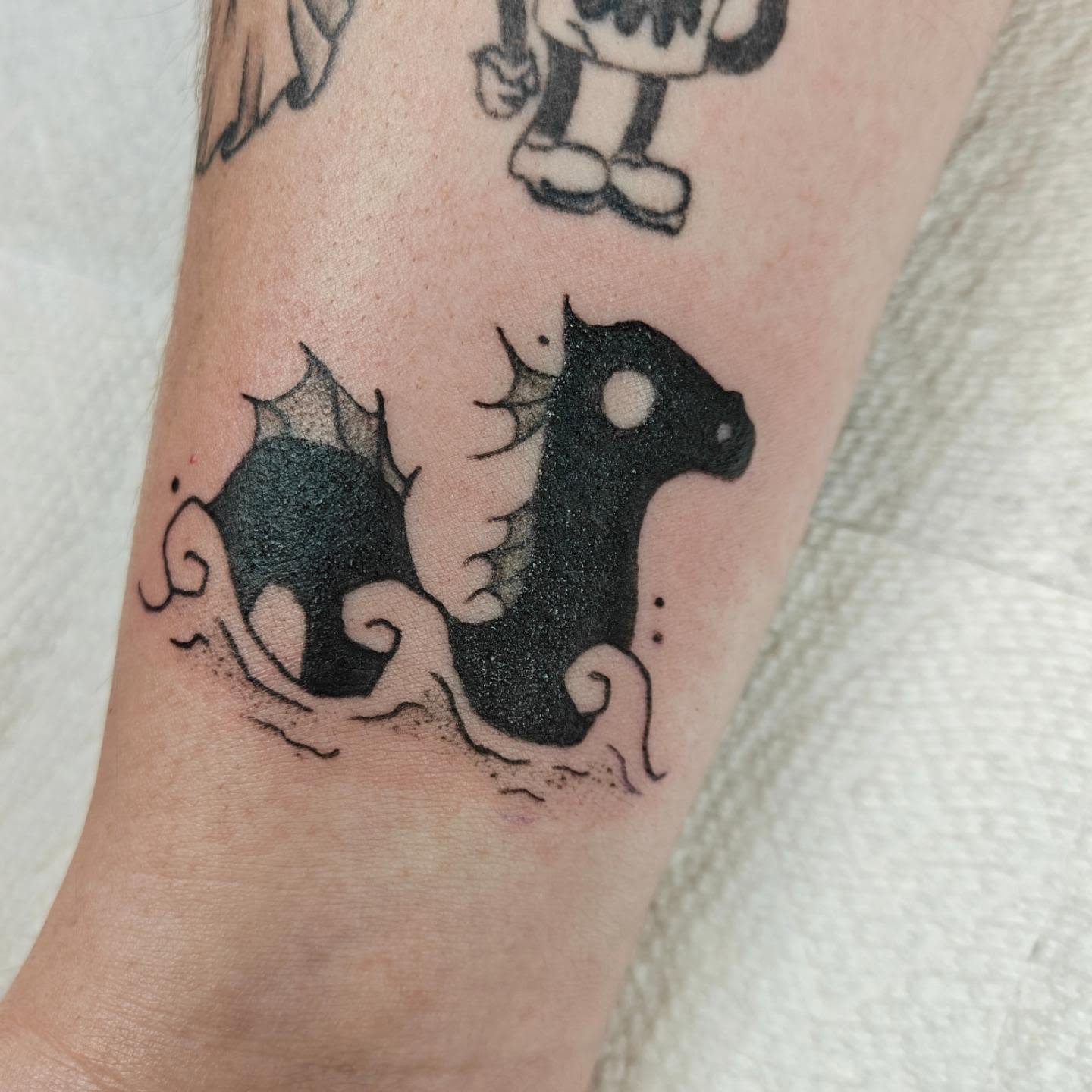 Bat black and grey tattoo on the forearm by Meg