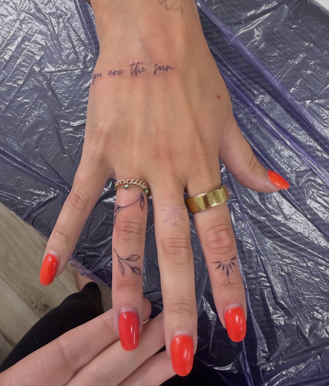 Sun fine line tattoo on the hand by Ink About Me - Amanda’s Fine Lines